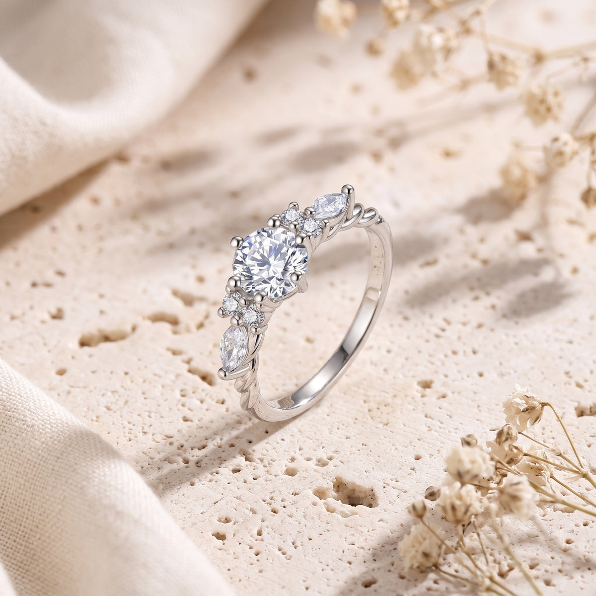 Detailed view of the sterling silver Claraluna ring's round and marquise simulated diamond setting.