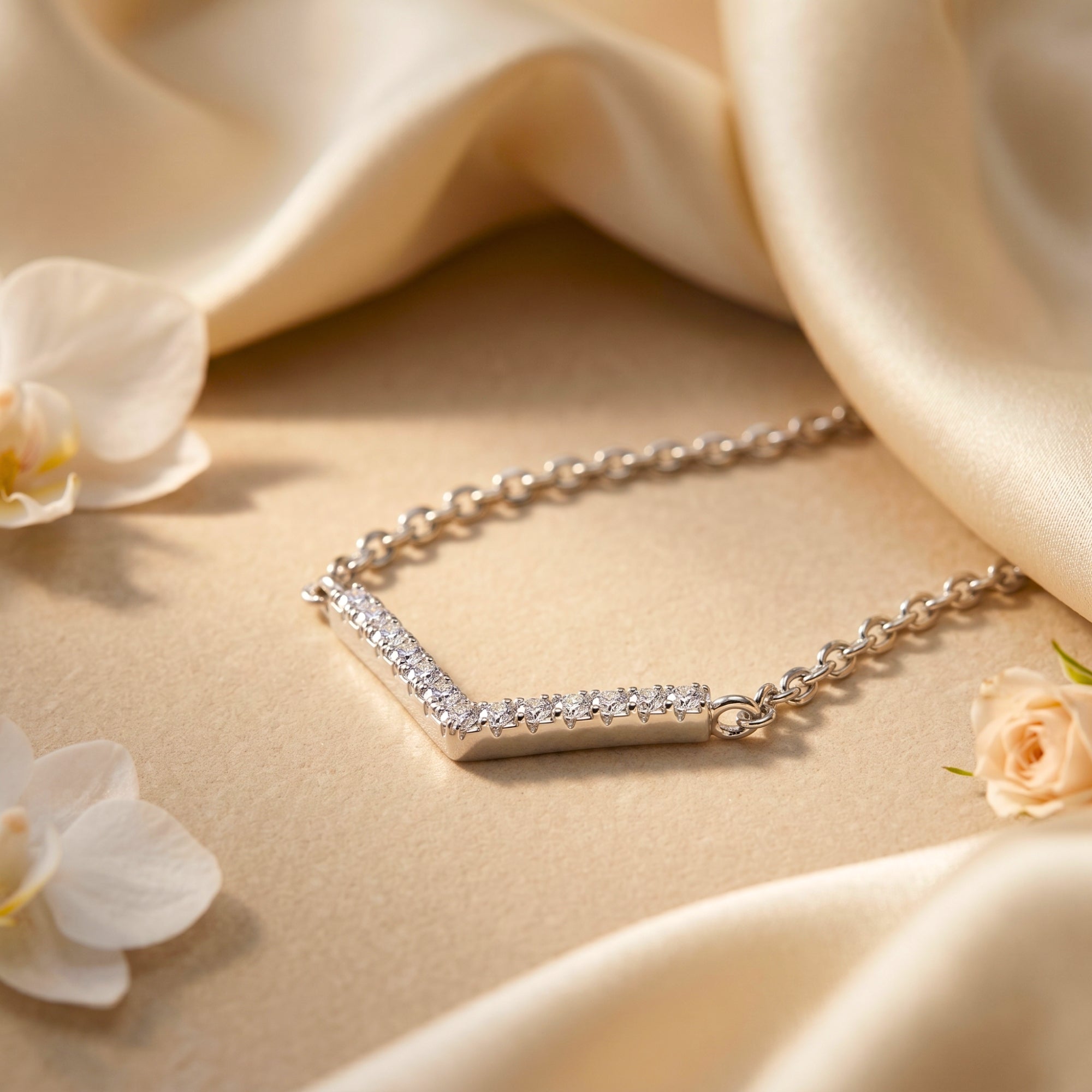 Macro view of silver chevron necklace with round moissanite stones.