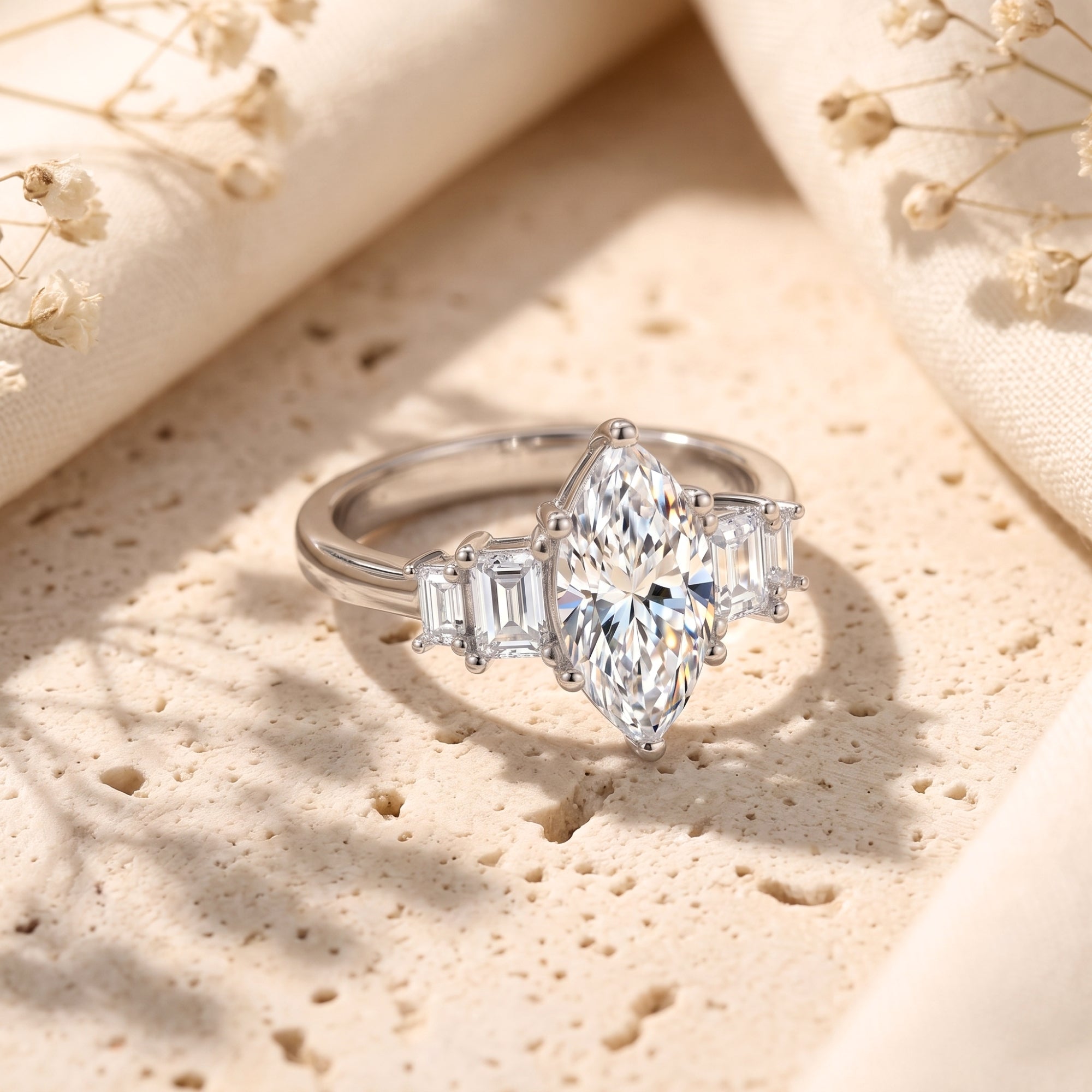 Detailed view of marquise and baguette simulated diamonds on a silver band.