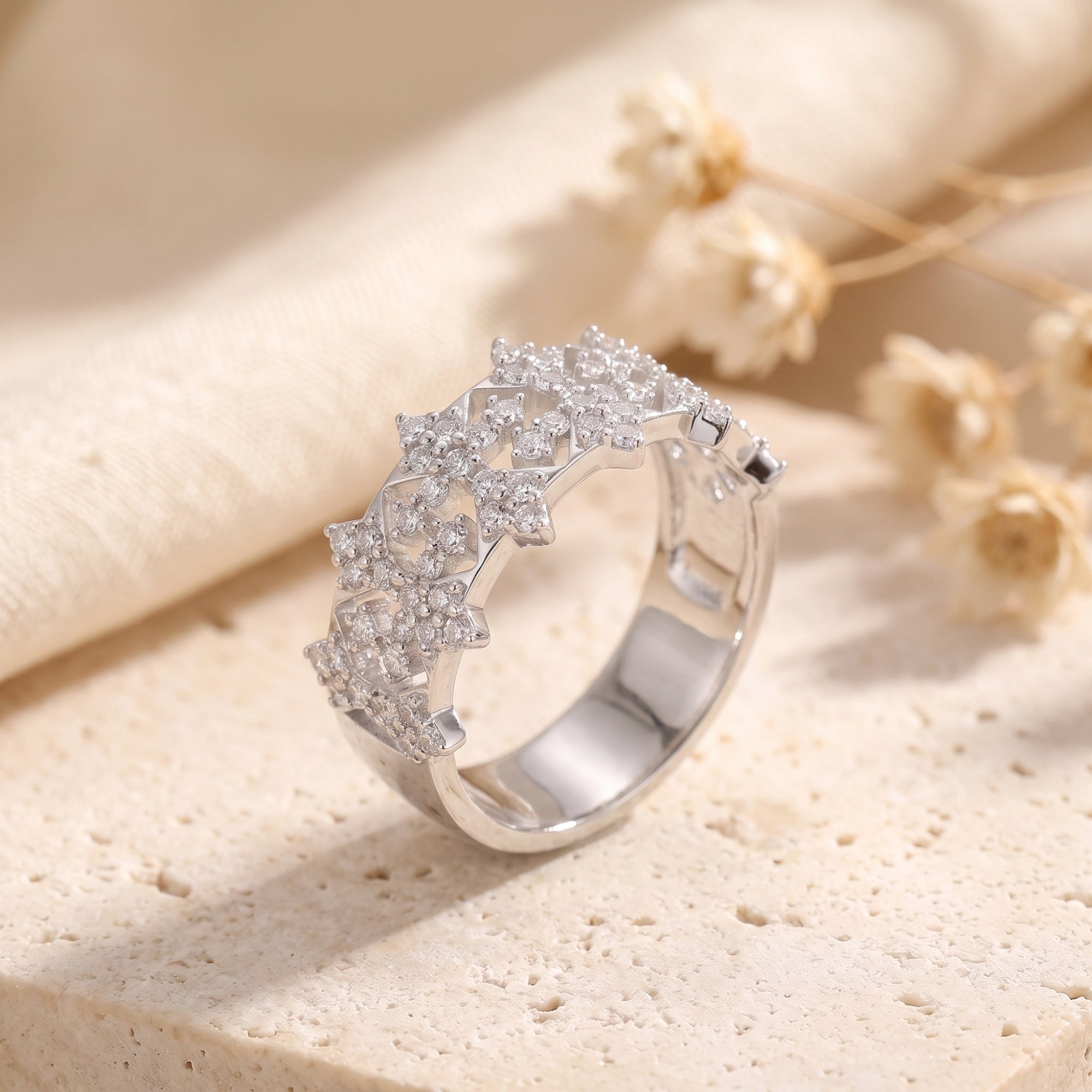 Close-up of a sterling silver snowflake crown ring with simulated diamond lattice.