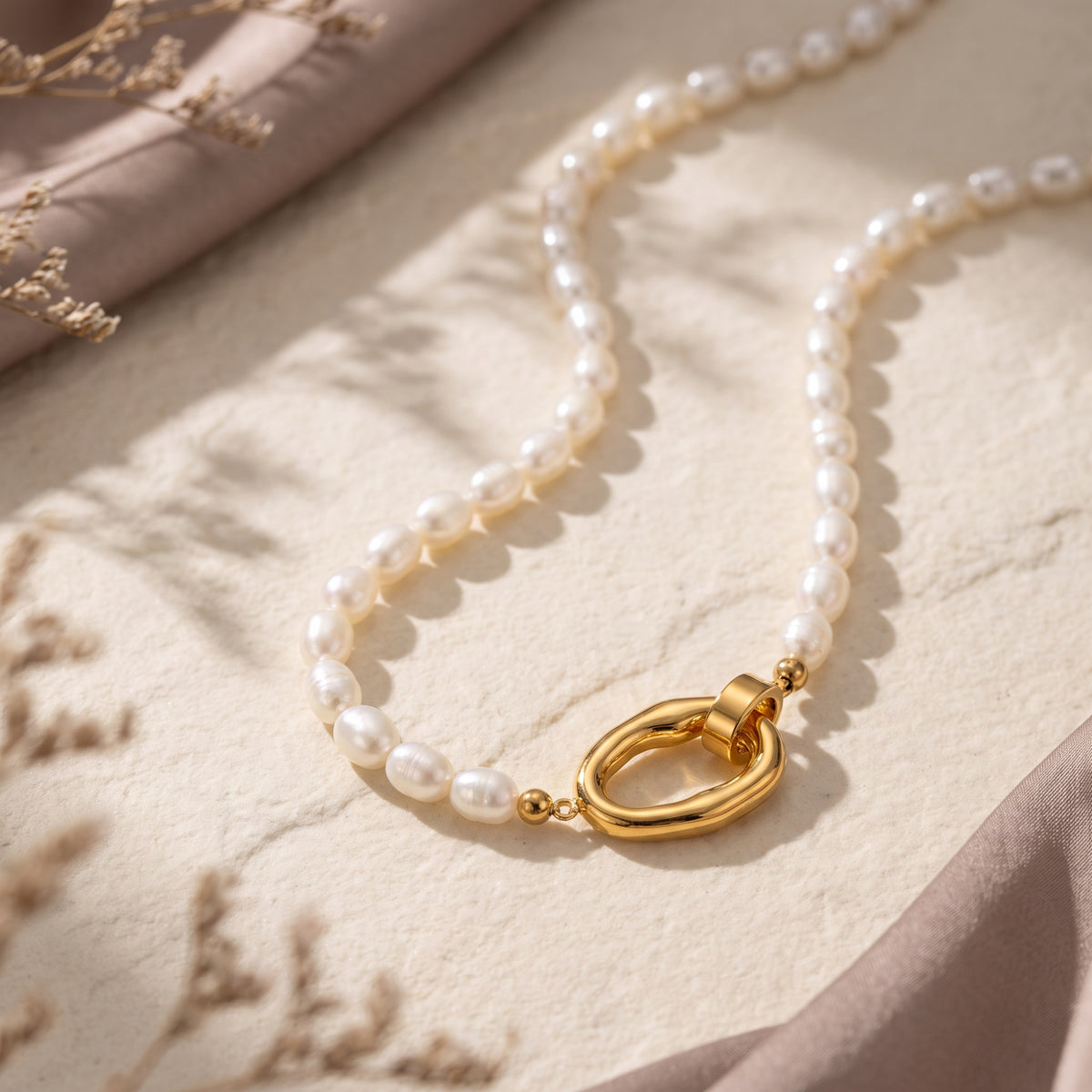 Detail of Audrielle necklace 18K gold PVD clasp and white rice pearls.