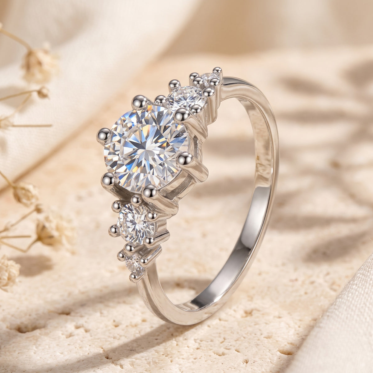 Angled side view of the silver ring showing its elevated prong setting and clustered accent stones