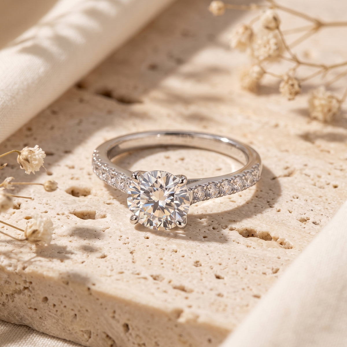 Close-up of a round brilliant simulated diamond ring with pavé silver band.