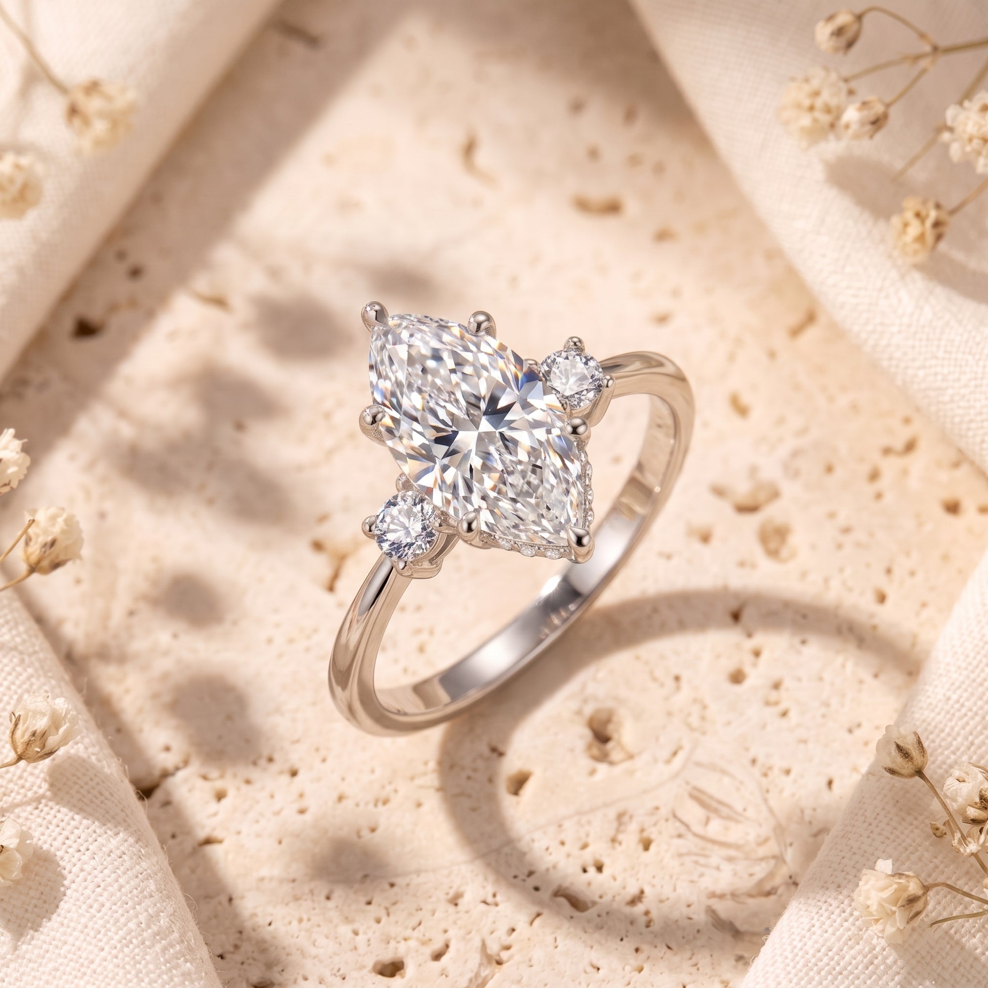 Detail view of a marquise and round cut simulated diamond silver ring.