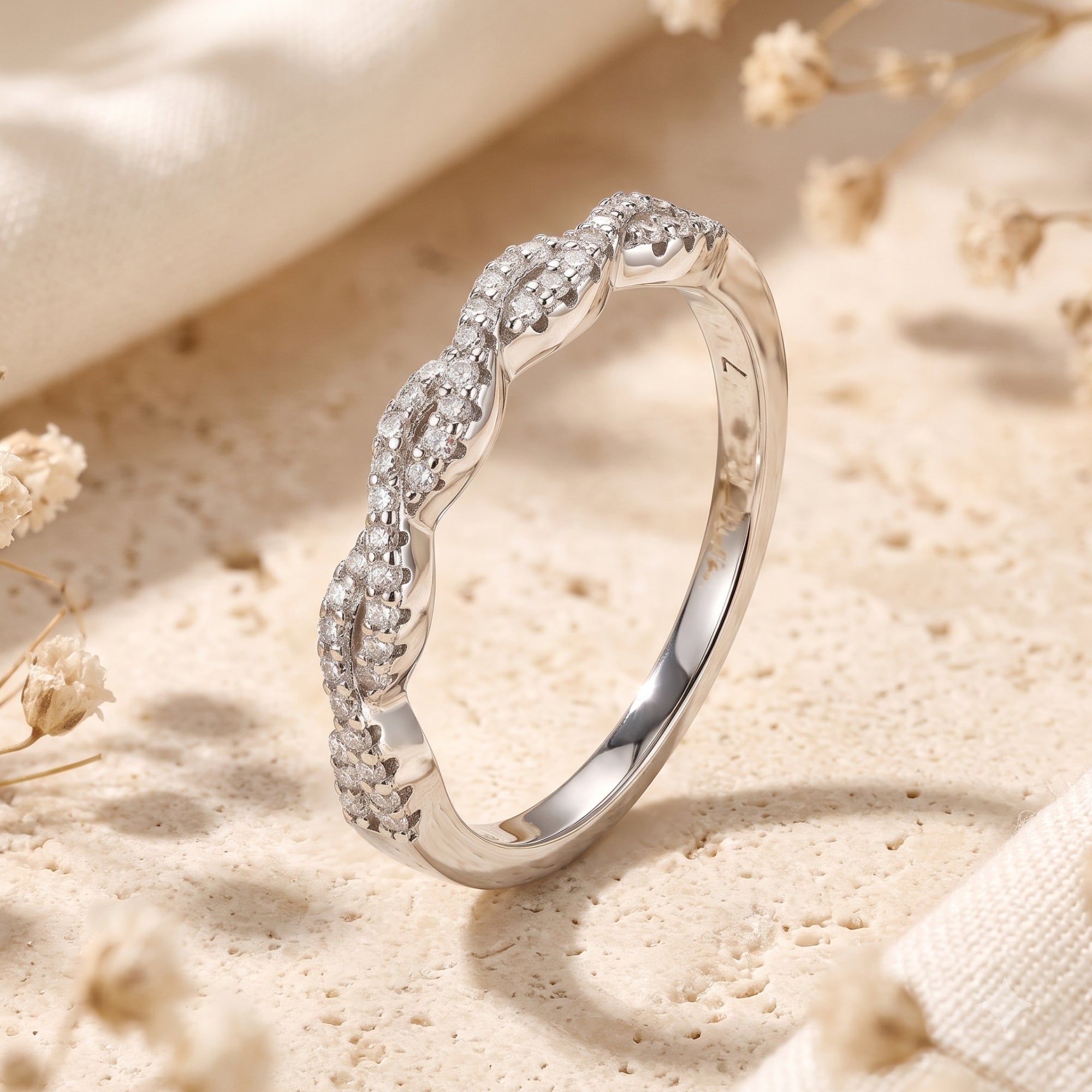 Close-up of Helena twisted S925 silver eternity ring showing round simulated diamond pavé setting.