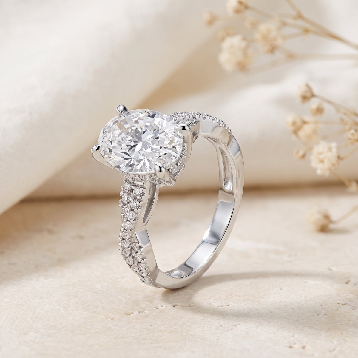 Side profile view of the silver infinity twist ring showcasing the elevated oval stone and band accents.