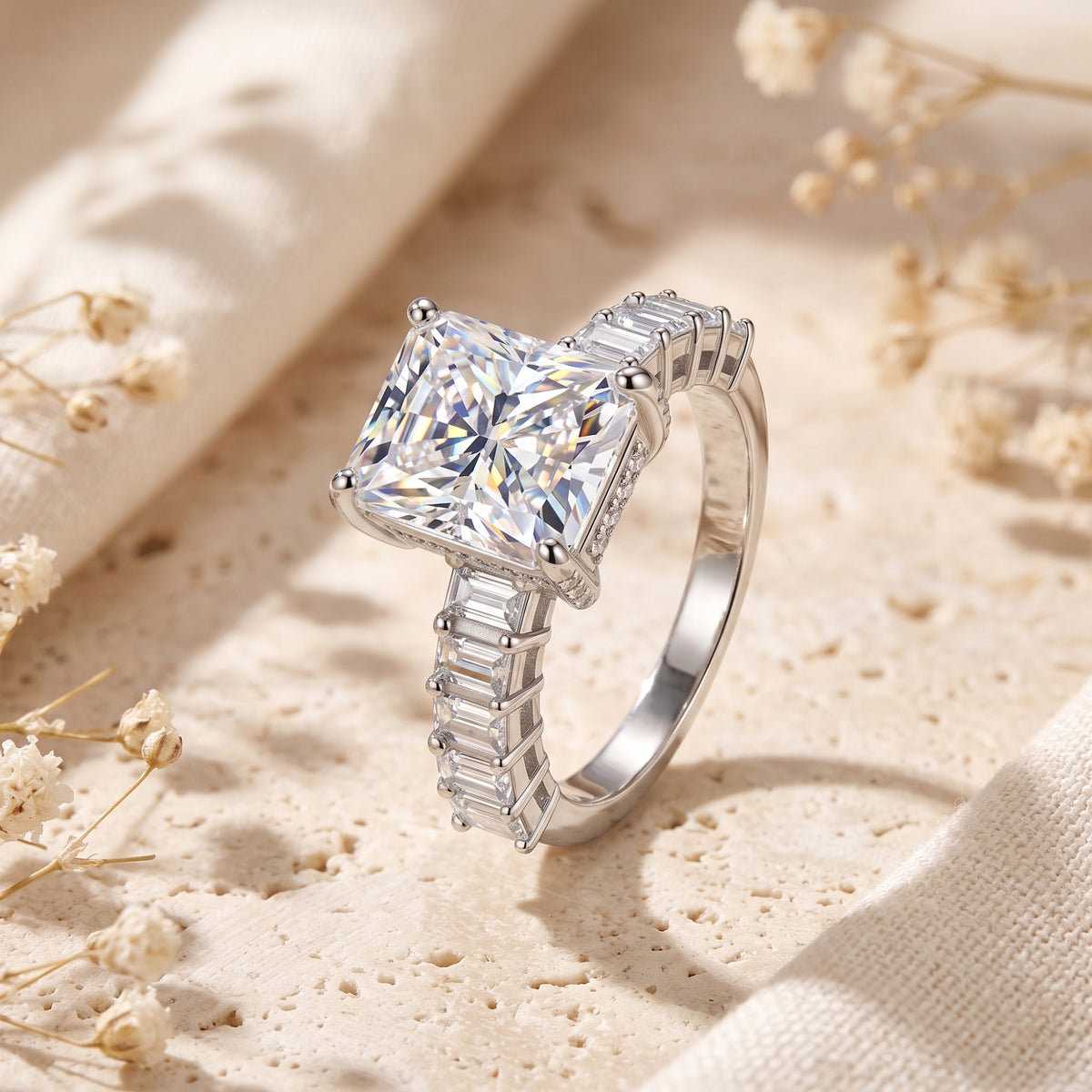 Angled side view of the sterling silver radiant cut simulated diamond ring with baguette side stones.