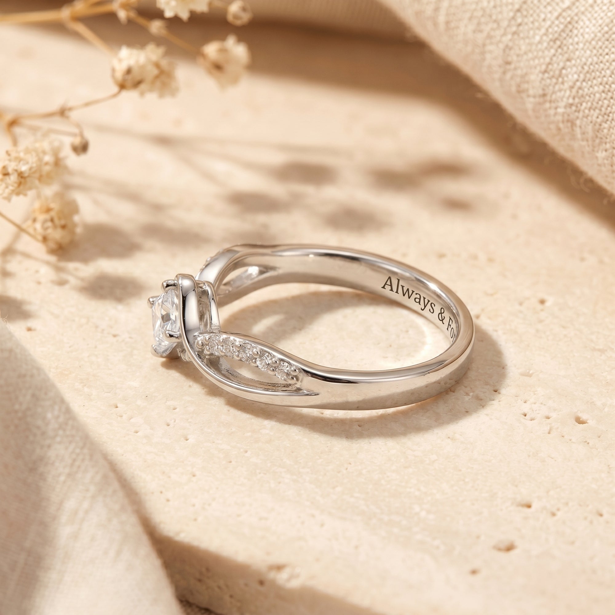 Side view of S925 sterling silver moissanite ring showing princess cut setting and band engraving.