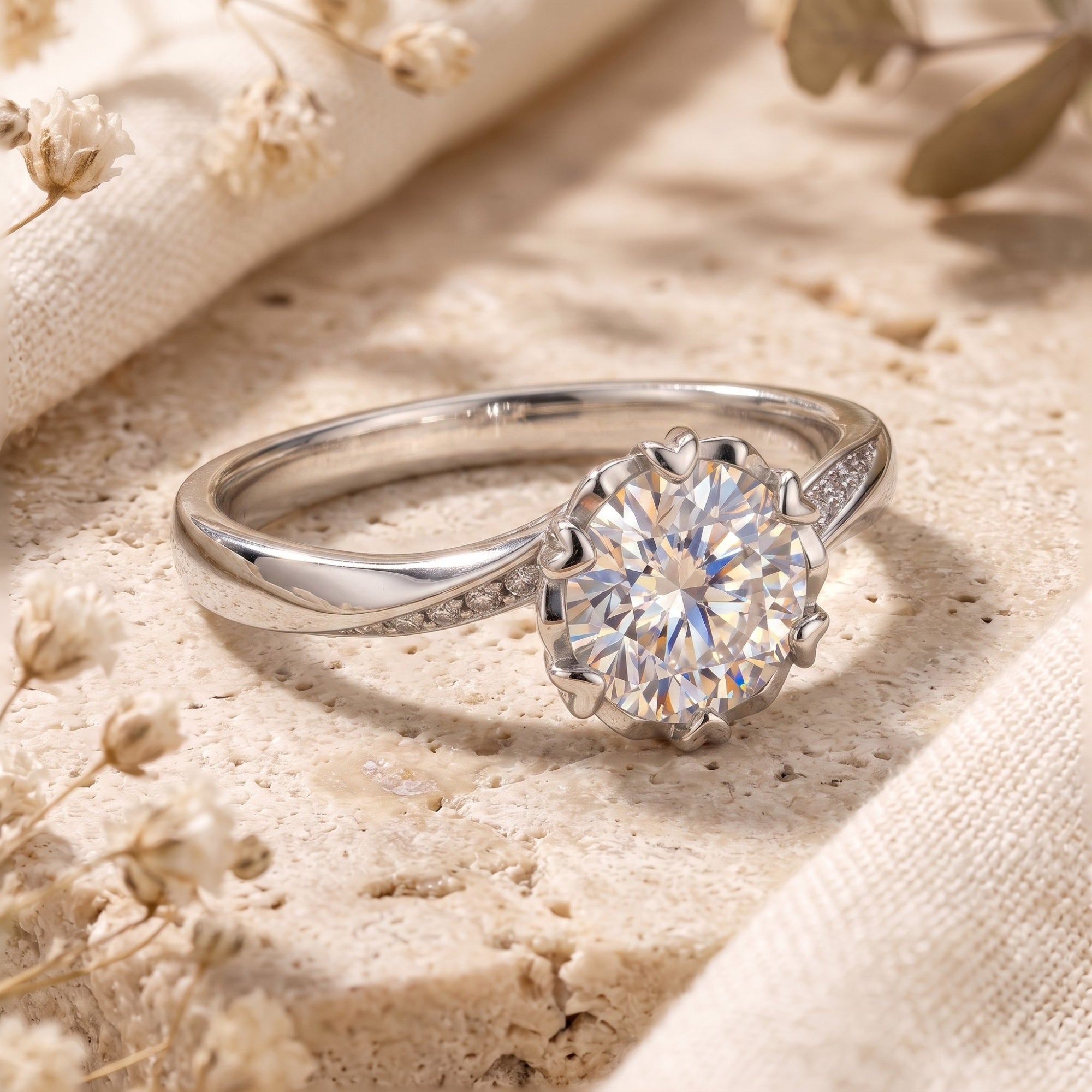 Close-up of silver Liorabelle ring showing round cut stone and heart-shaped prongs.