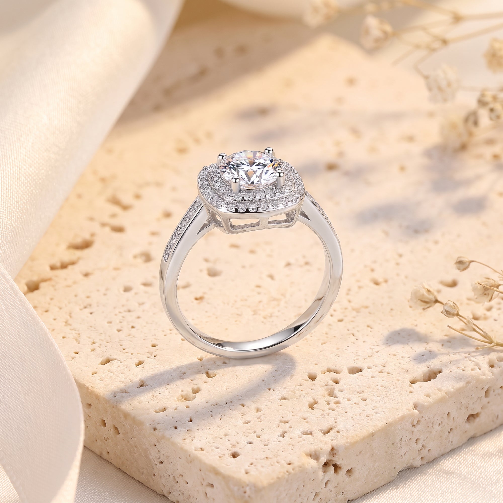 Macro view of sterling silver Juliette ring showing round center stone and pavé double halo.