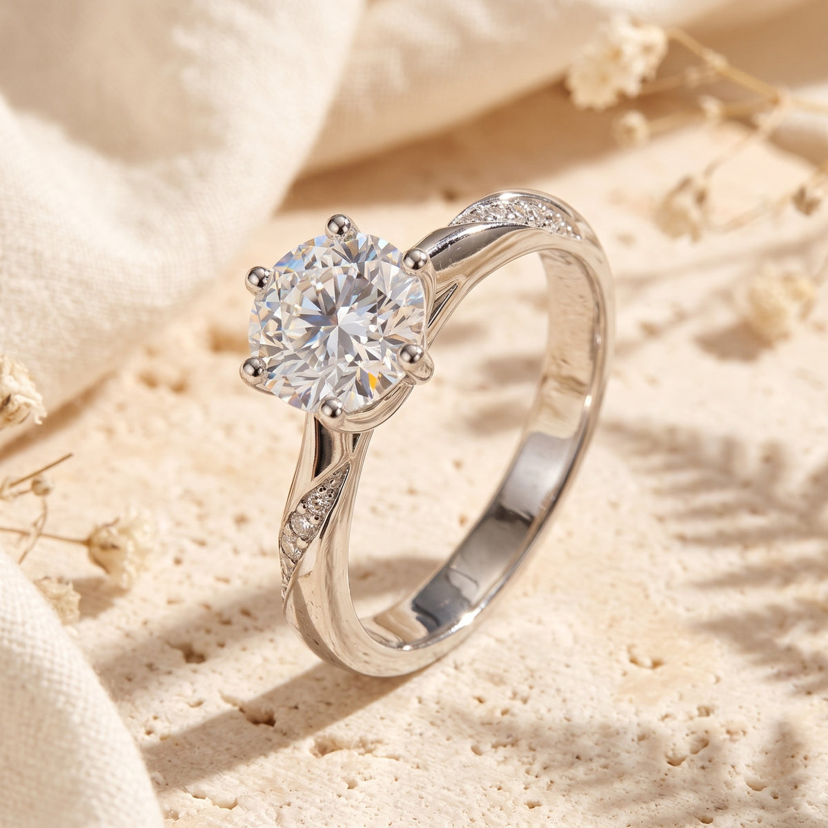 Angled close-up of a silver-tone twist ring with a six-prong solitaire setting and pavé-accented band.
