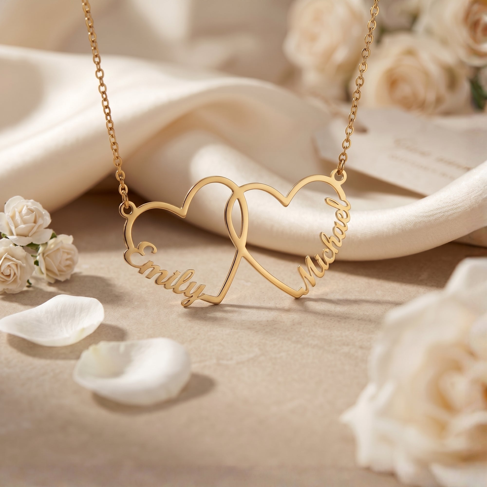 Gold stainless steel interlocking heart necklace close-up with roses.