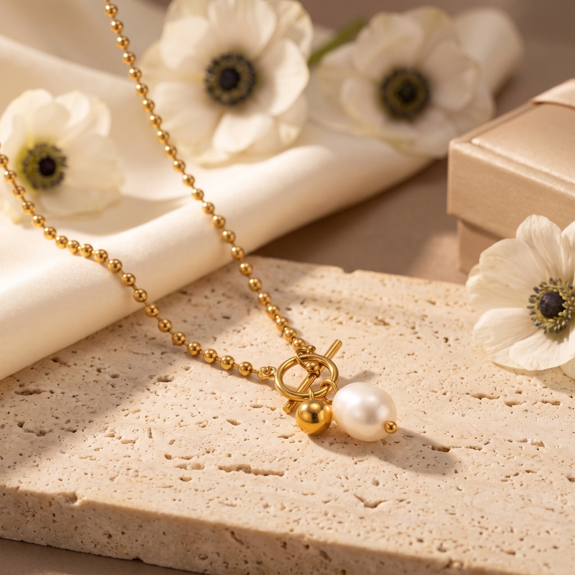 Close-up of the 18K gold finish toggle clasp and baroque freshwater pearl.