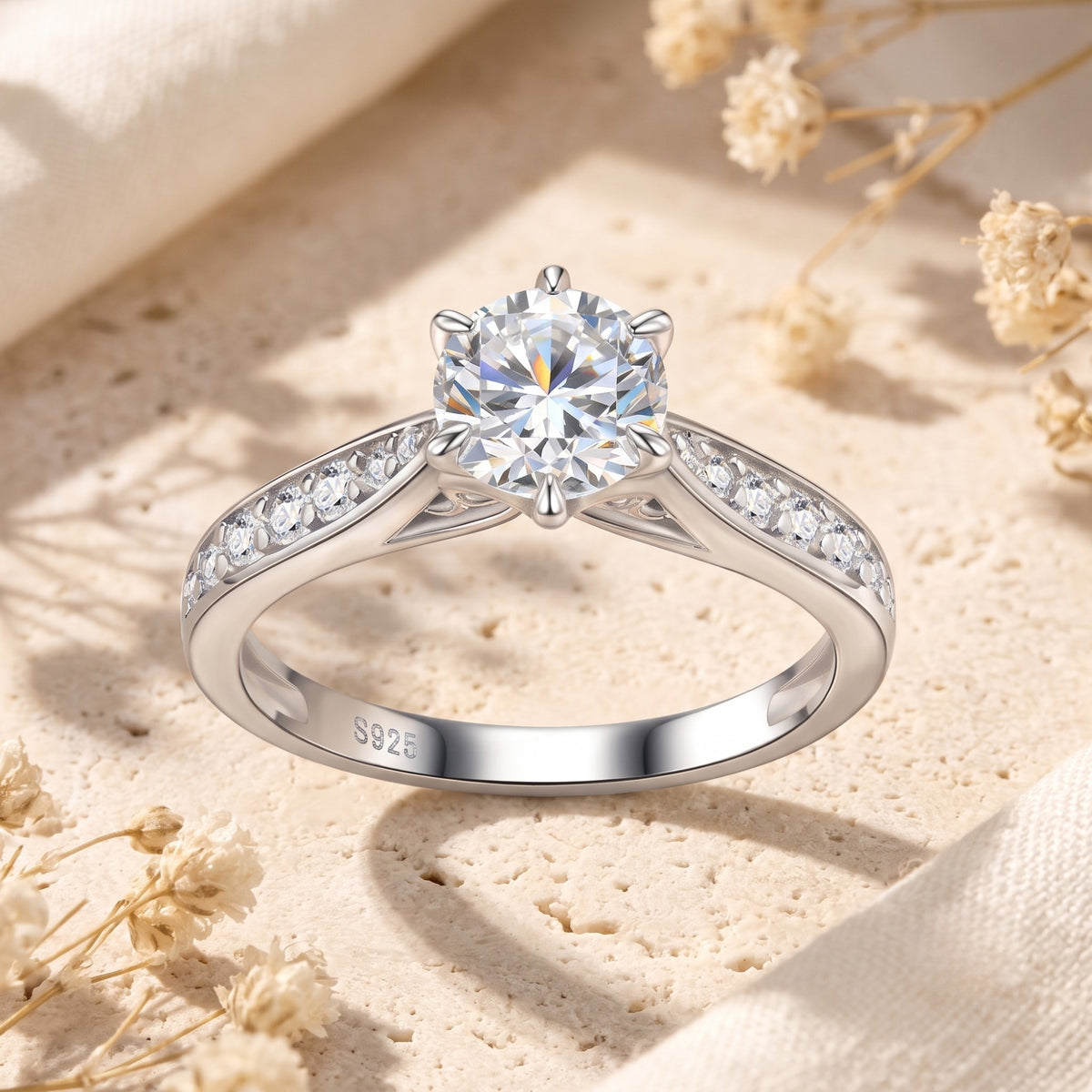 Front view of the silver solitaire ring displaying a round clear stone in a six-prong crown setting.