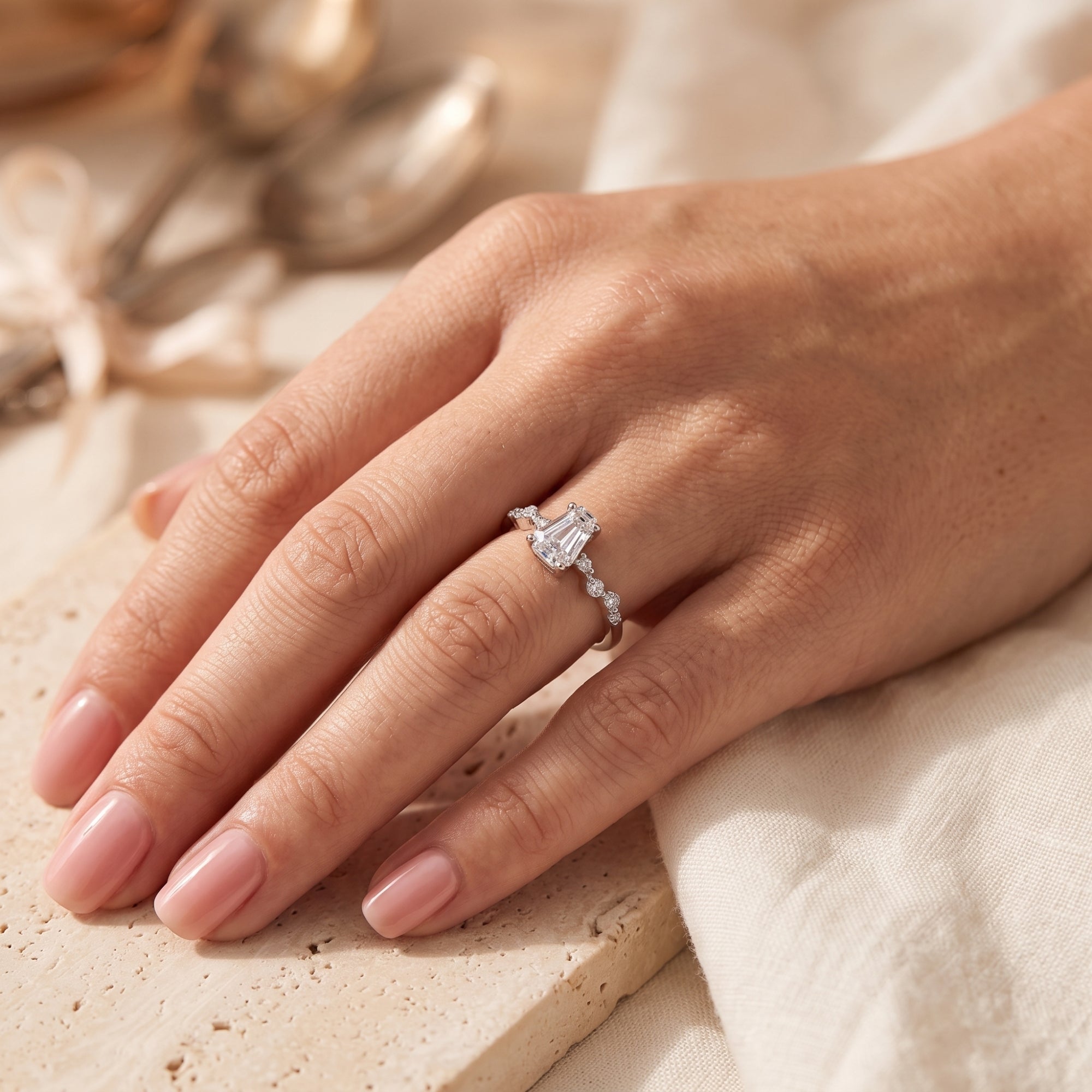 The silver Rosmerta coffin-cut simulated diamond ring worn on a finger, styled with a neutral background.