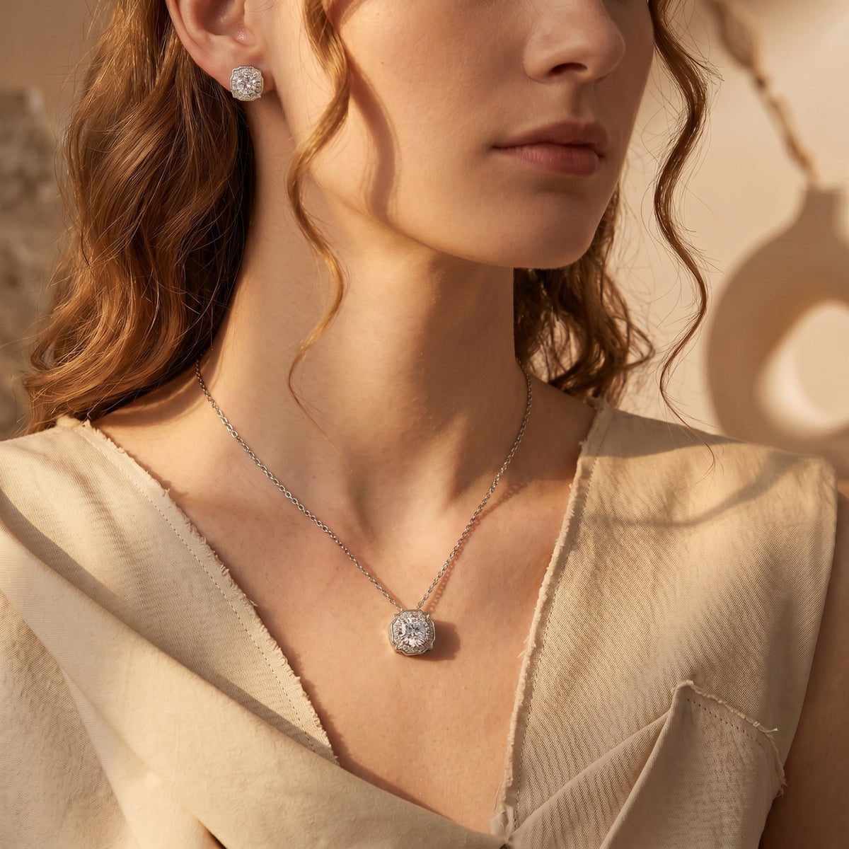 Model wearing the Aurestella silver moissanite halo jewelry set with a round-cut pendant and matching earrings.