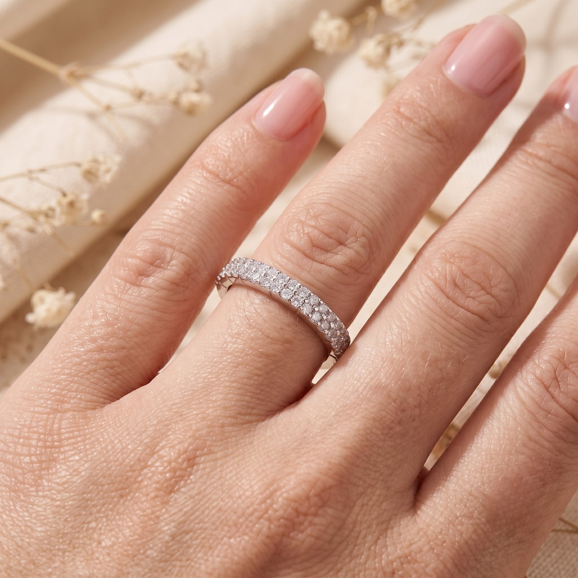Close-up of the cubic zirconia pavé ring on a finger for scale reference.