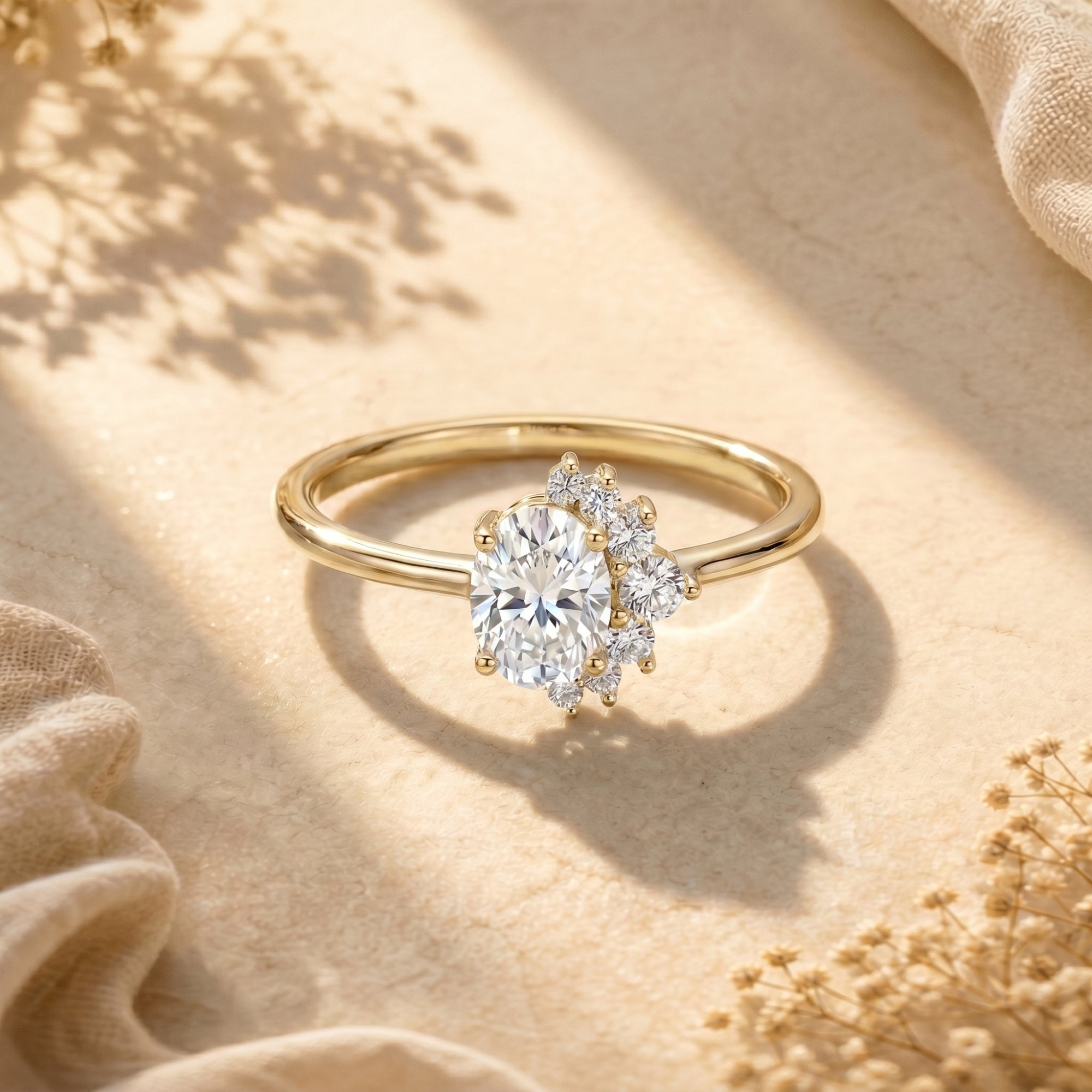 Yellow gold sterling silver ring with a 2-carat oval moissanite center stone and side cluster accents.