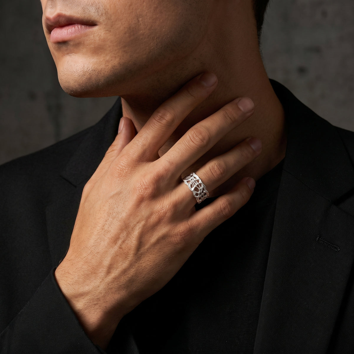 Person wearing the fine-silver open band ring on the ring finger while resting a hand near the neck.