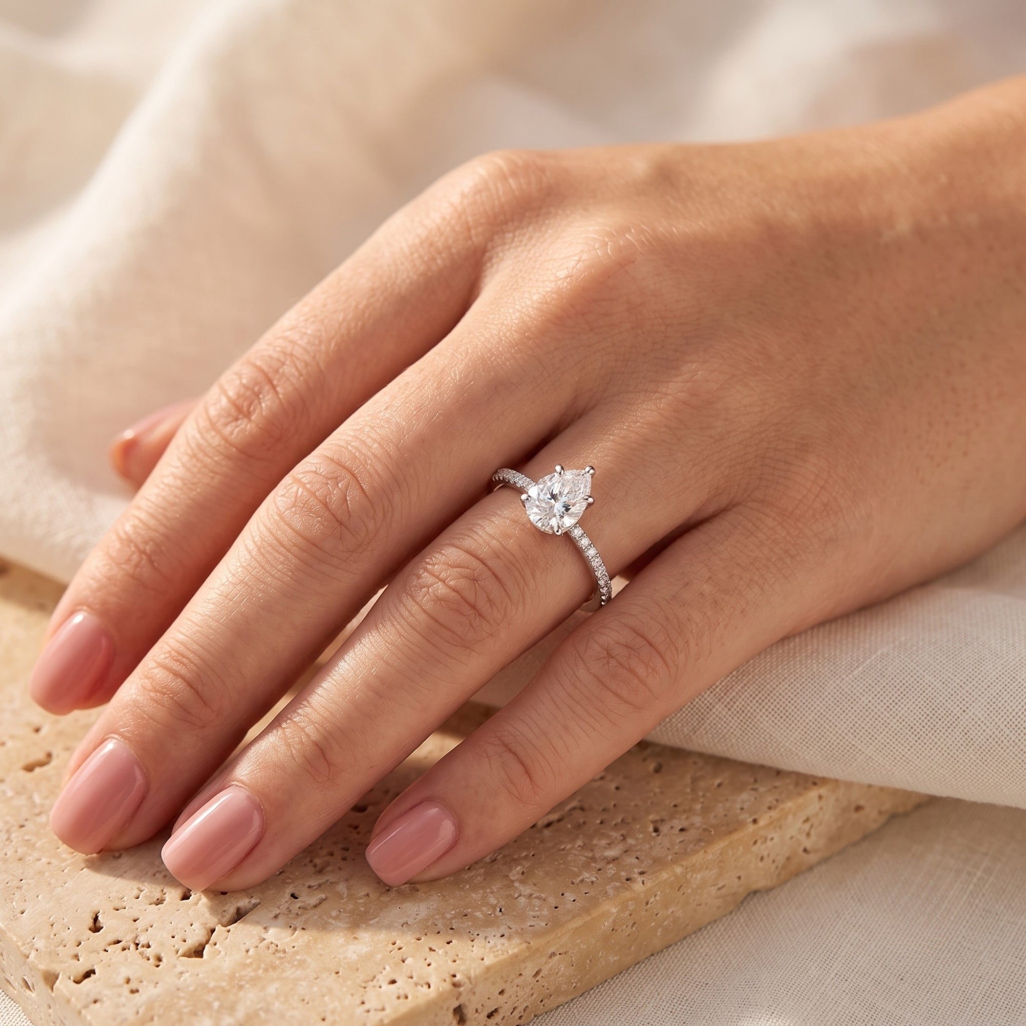 Sterling silver pear cut ring on a model's hand, showing scale and everyday wear.