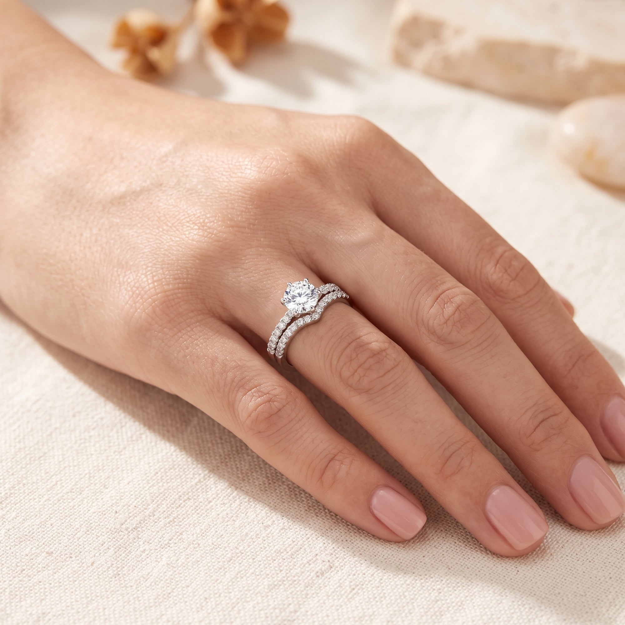 Close-up of Amariel silver nesting ring set with round simulated diamond on a finger.