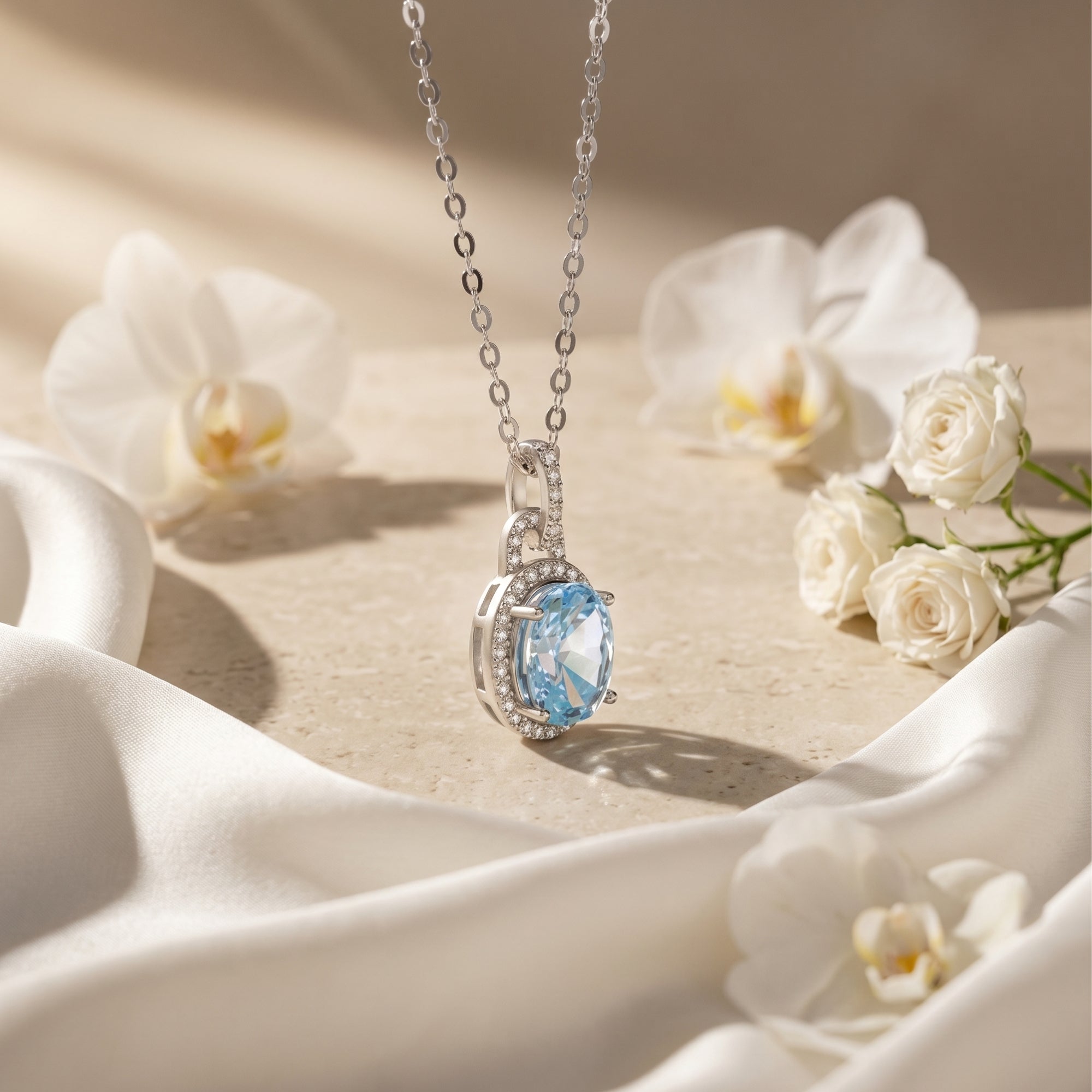 Close-up side view of the Bianca aquamarine pendant showing the silver halo setting.
