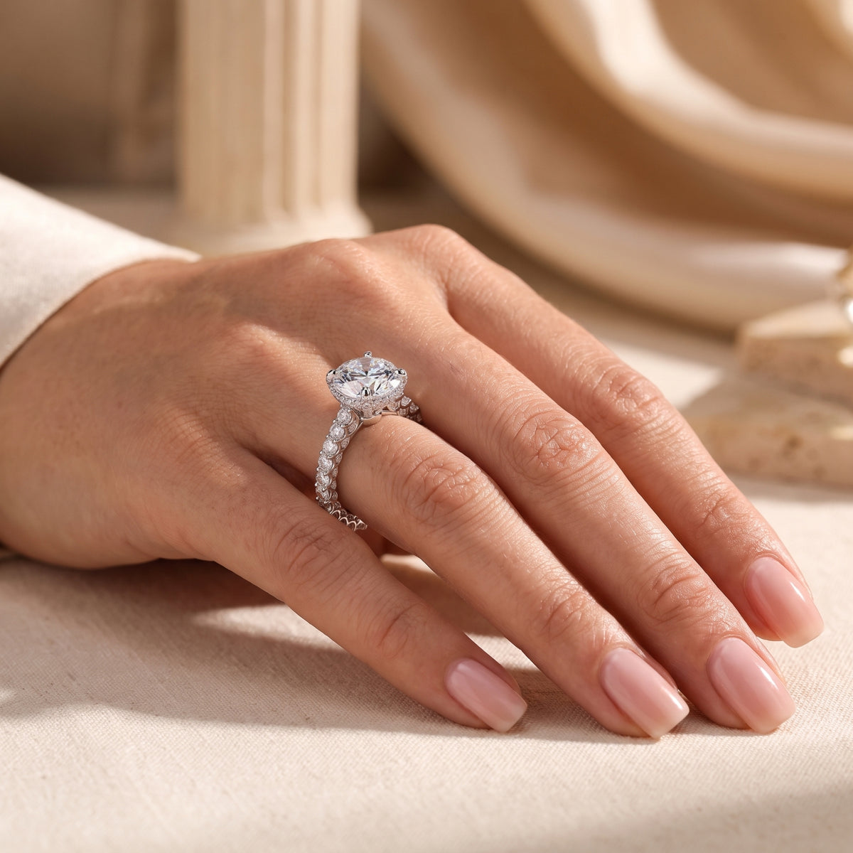 Side view of the silver ring worn on a hand, highlighting its elevated setting.