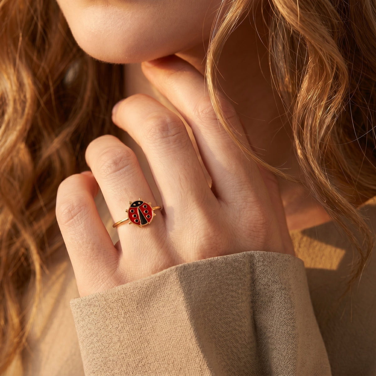 Model wearing the adjustable gold ladybug ring on her hand.