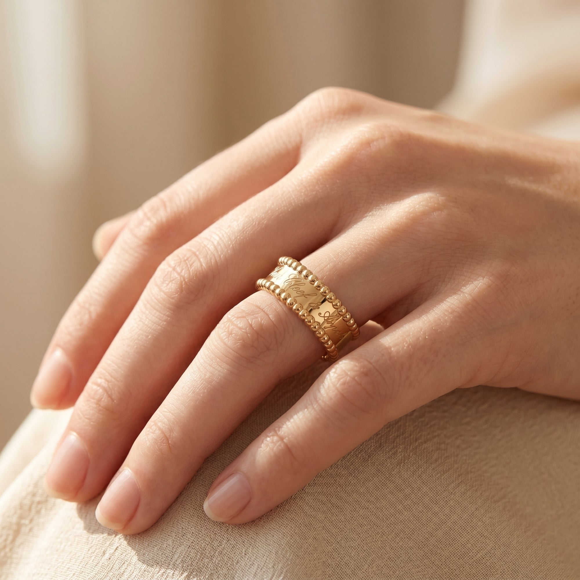 The Vowbound Ring in 18K gold vermeil worn on a woman's hand, highlighting the personalized engraved band.