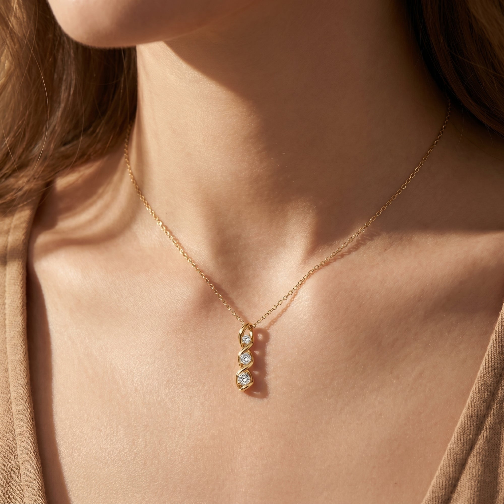 Gold Adrastia moissanite swirl pendant necklace worn by a model, showcasing the elegant drop design.