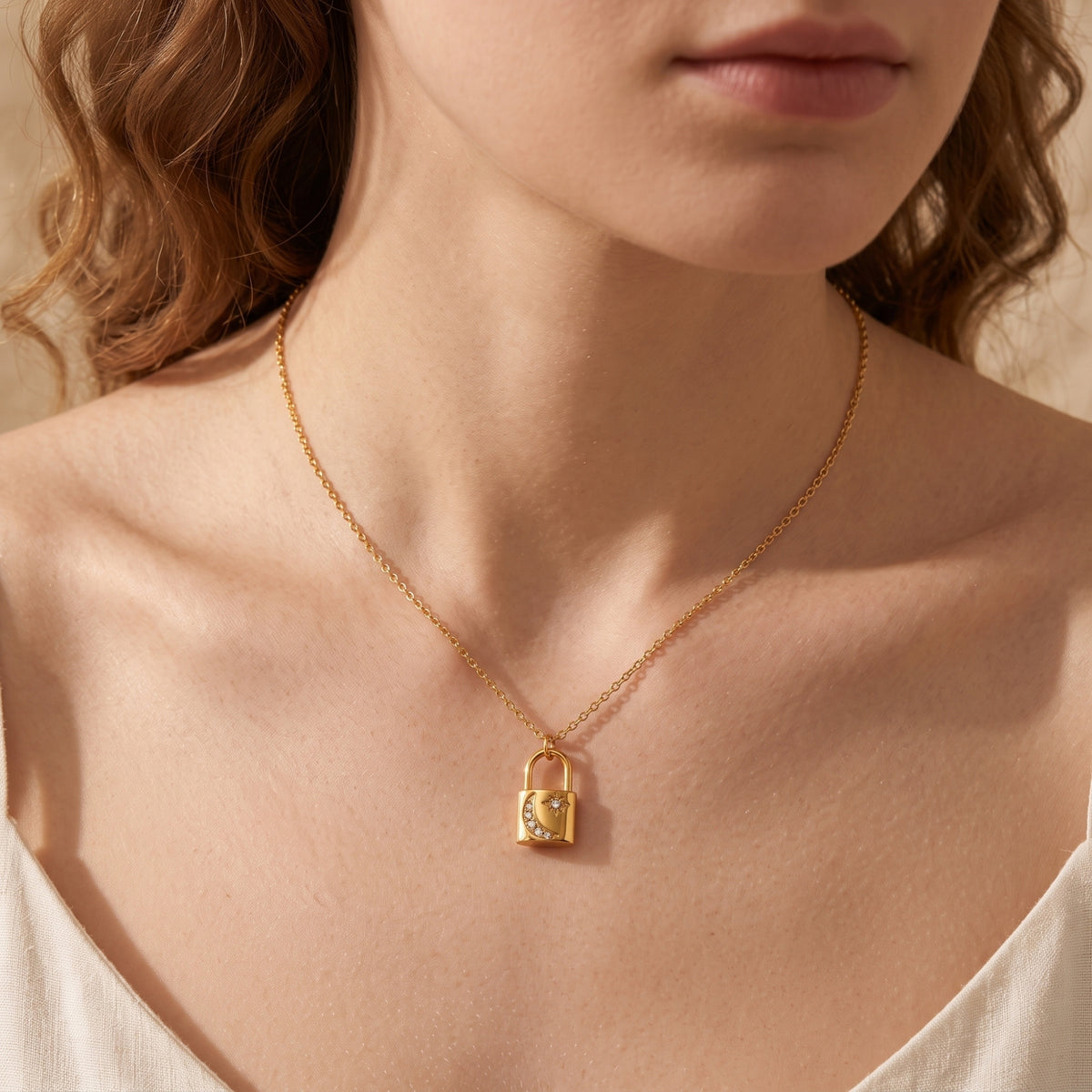 Front view of the gold Selenia pendant necklace worn by a model.