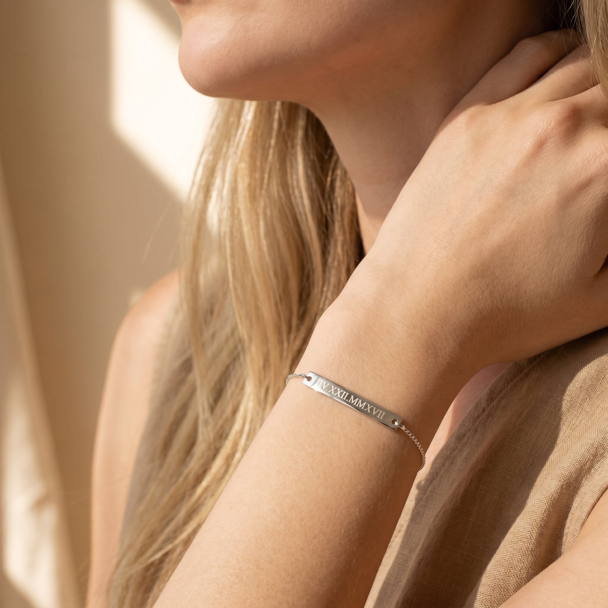 Silver Eleanor Bar Bracelet with Roman numeral engraving worn by a model in a lifestyle setting.