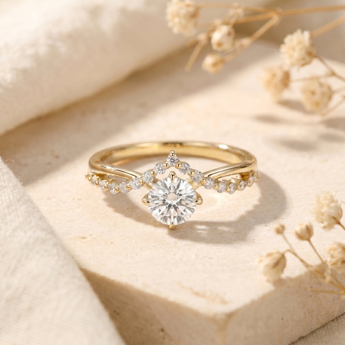 Gold Caladienne crown promise ring featuring a 1-carat round-cut moissanite center stone on a lifestyle background.