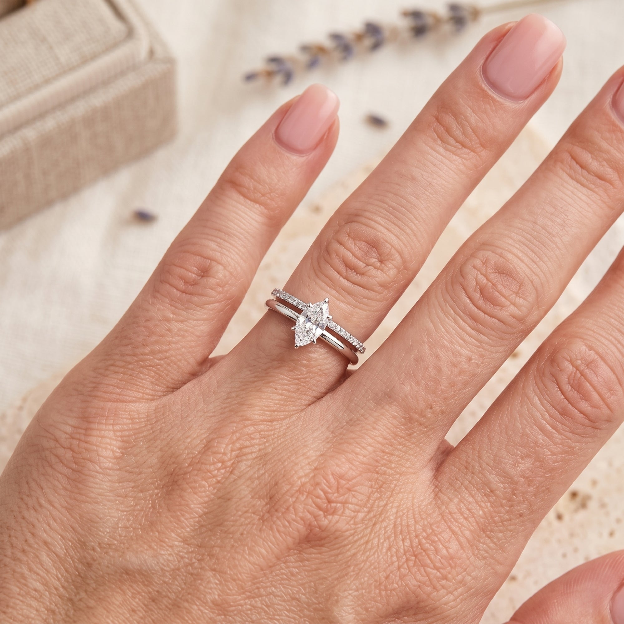 Top-down view of the Luvienne marquise simulated diamond ring set on a hand to show scale and fit.