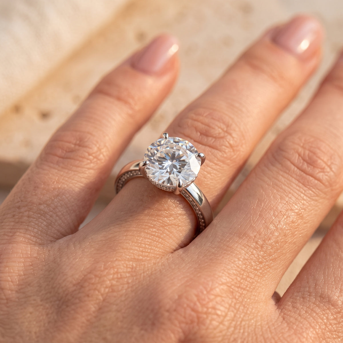 Top-down view of the 11mm round-cut simulated diamond ring on a finger to show scale and brilliance.