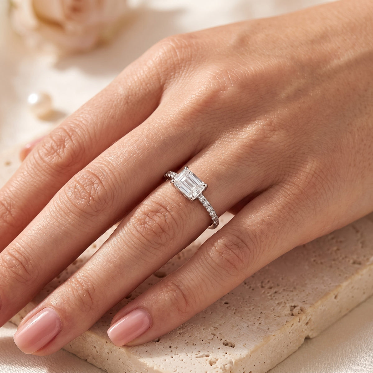 Woman wearing the Sarielle East-West silver ring featuring a horizontal emerald-cut simulated diamond.