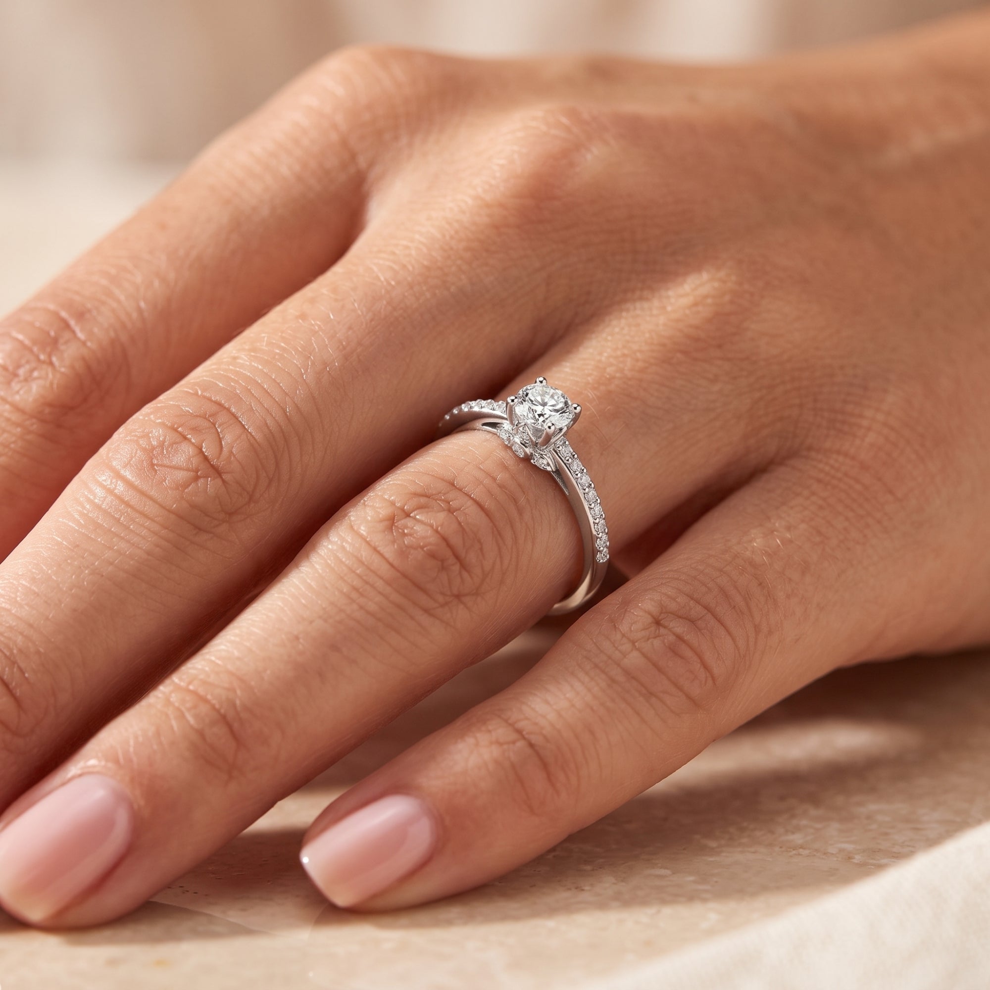 Close-up of the sterling silver Josephine ring with a round-cut simulated diamond on a finger.