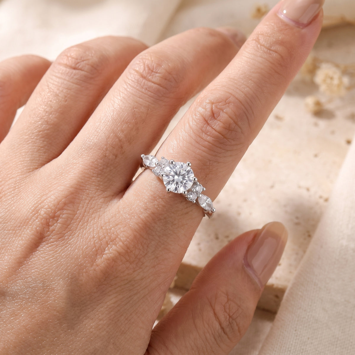 Sterling silver Claraluna ring with a 6.5mm simulated diamond shown on a finger for scale.