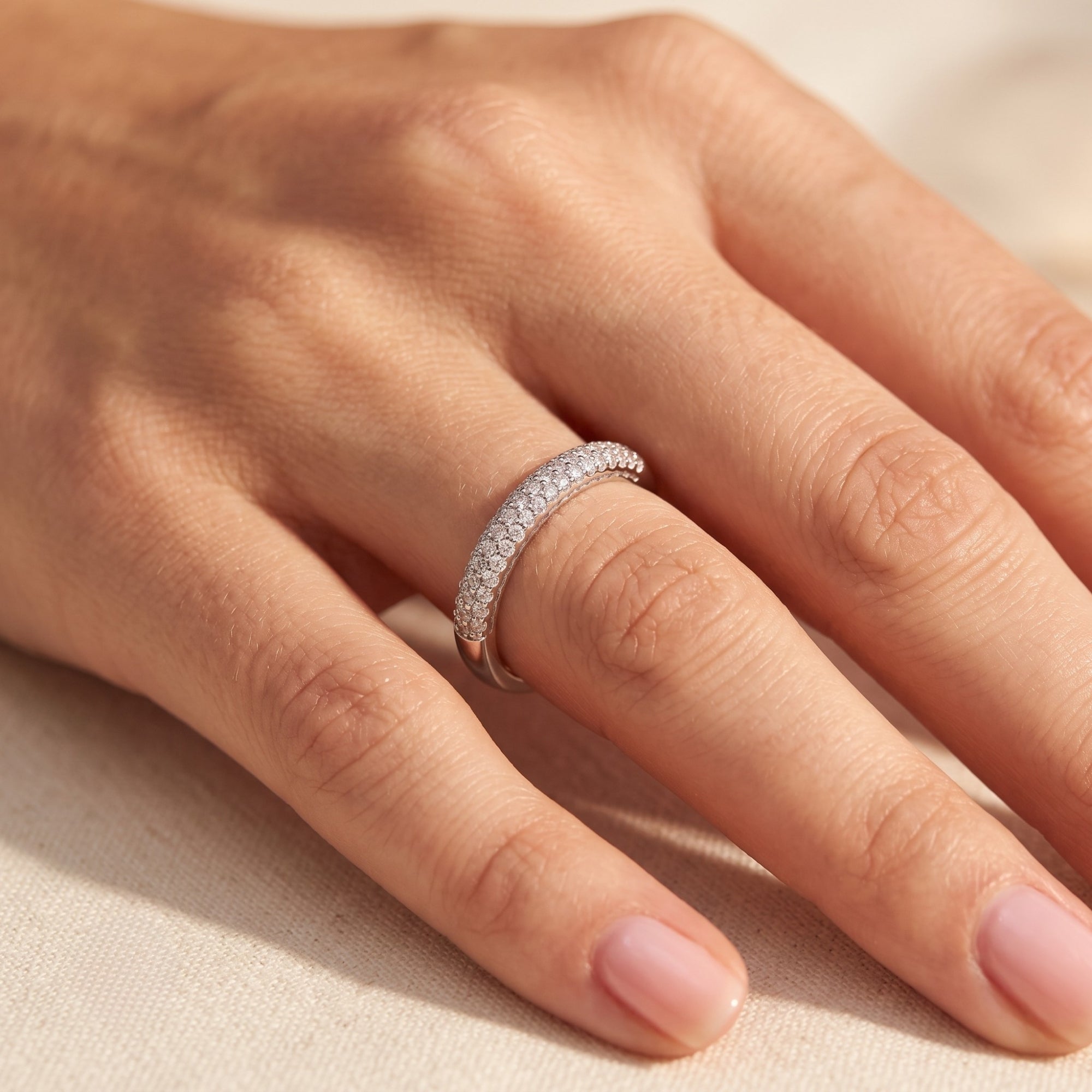 Side view of the Florentina sterling silver simulated diamond ring worn on a model's hand.