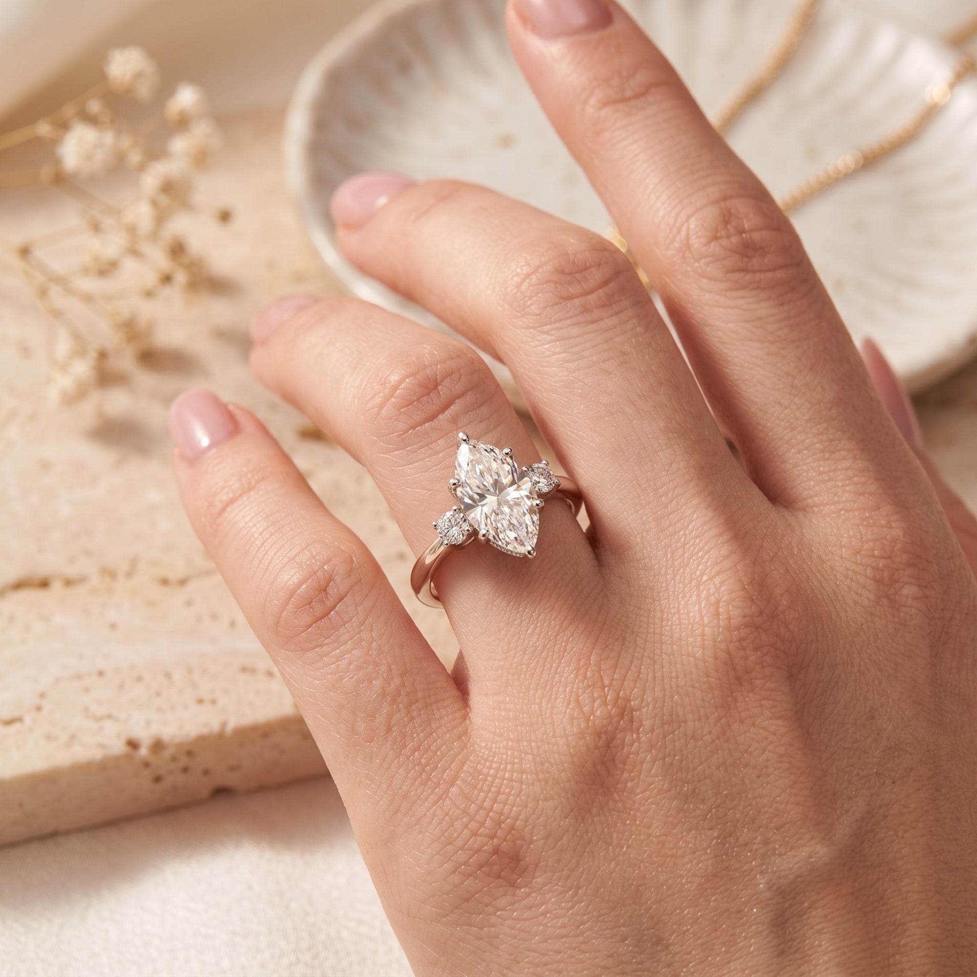 Marquise cut simulated diamond ring in silver shown on a hand.
