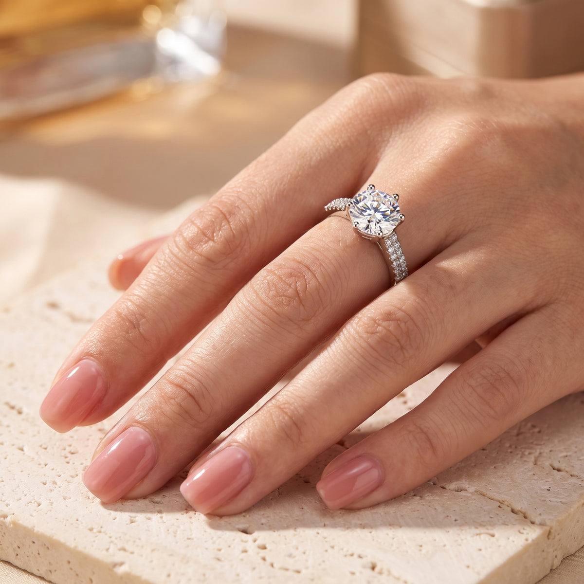 Round-cut simulated diamond sterling silver ring shown on a model's finger.