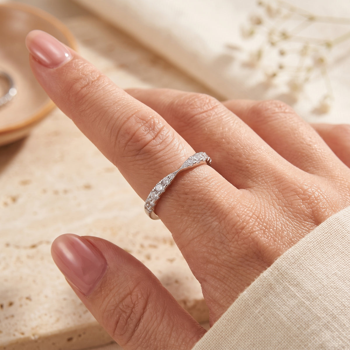 S925 sterling silver wave promise ring with simulated diamonds on a finger, showing its delicate scale.