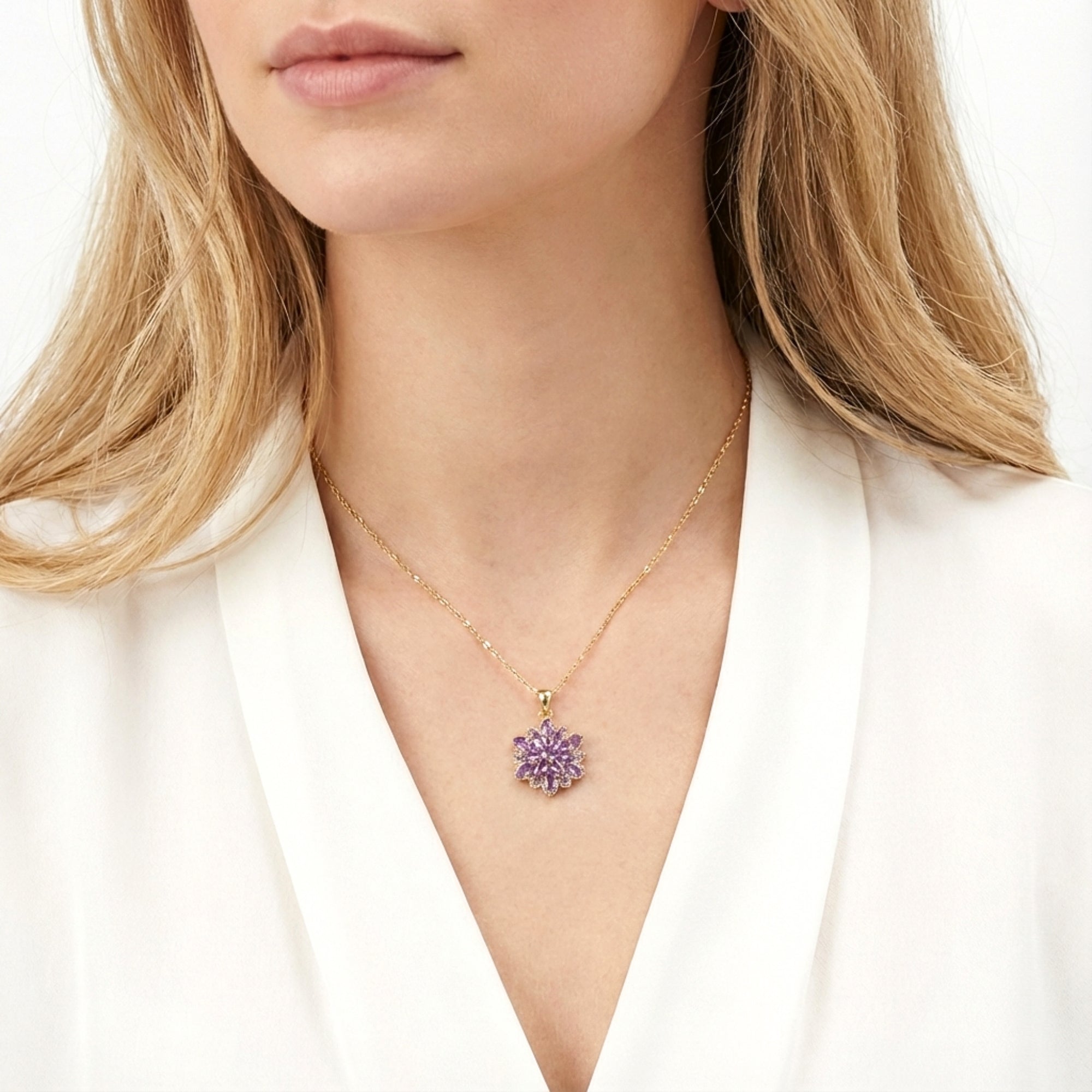 Gold-finished stainless steel Floriana pendant necklace with purple simulated amethyst worn by a model in white.