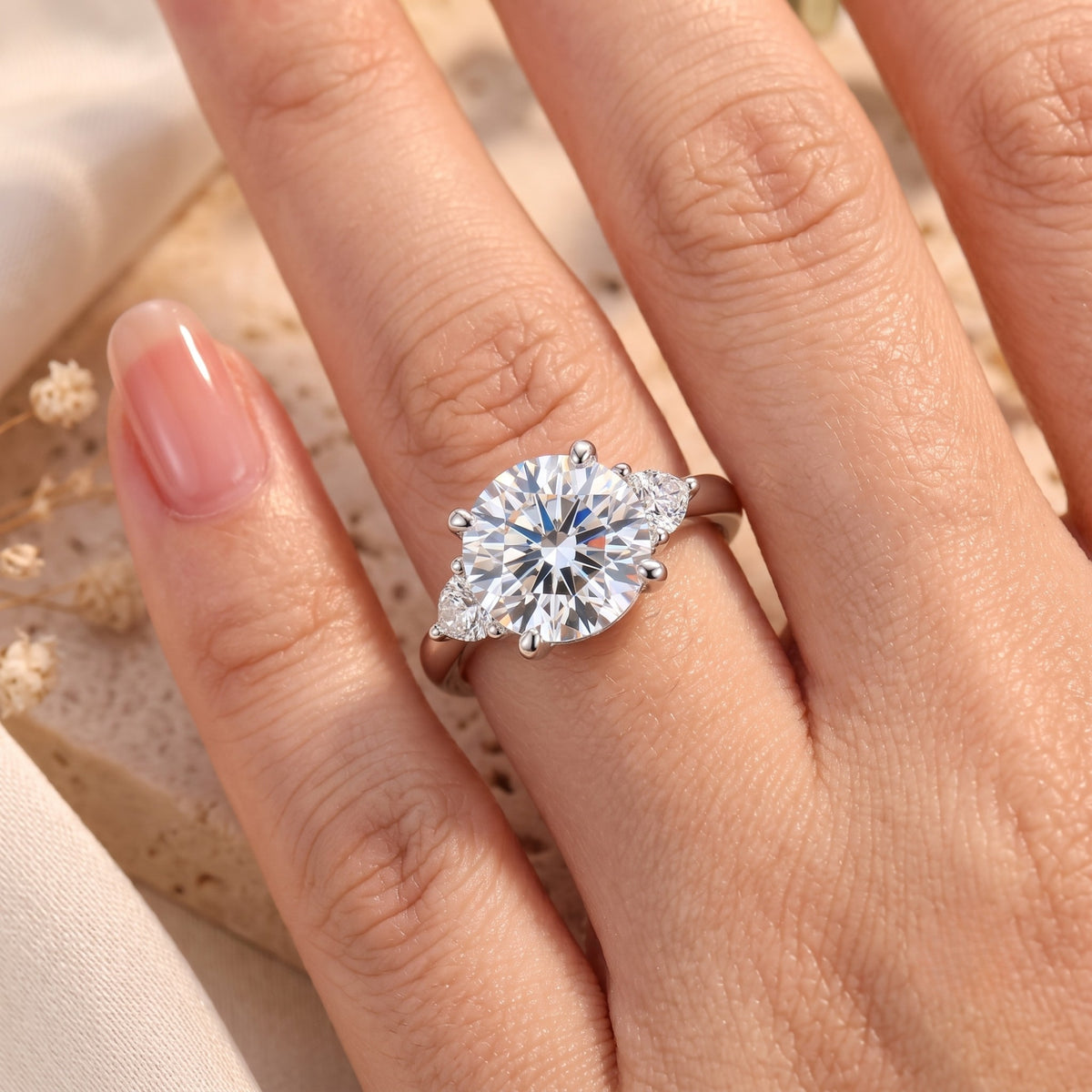 Close-up of round-cut cubic zirconia promise ring on a hand.