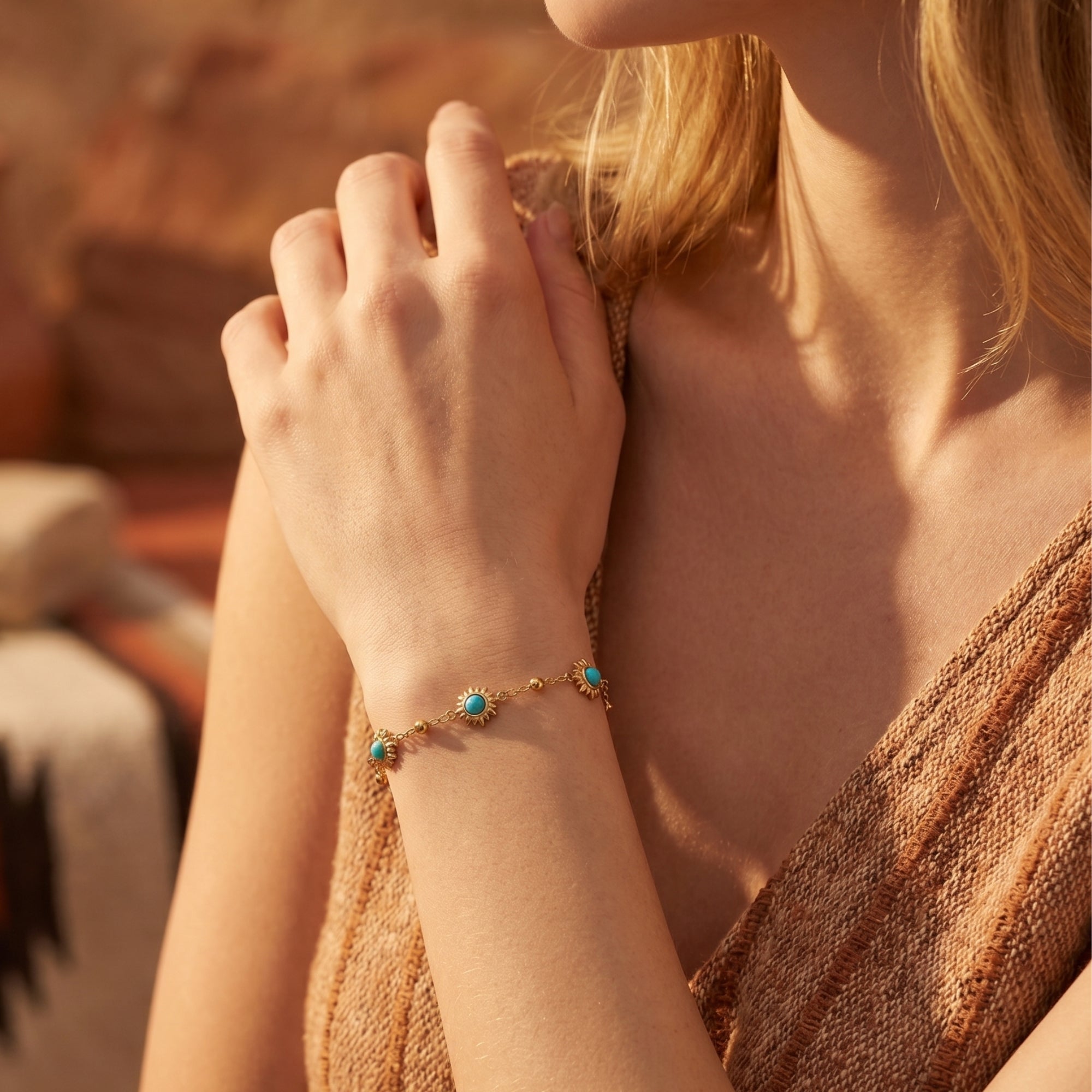 Gold Palo Verde turquoise sunburst bracelet worn on a woman's wrist with a boho desert aesthetic.