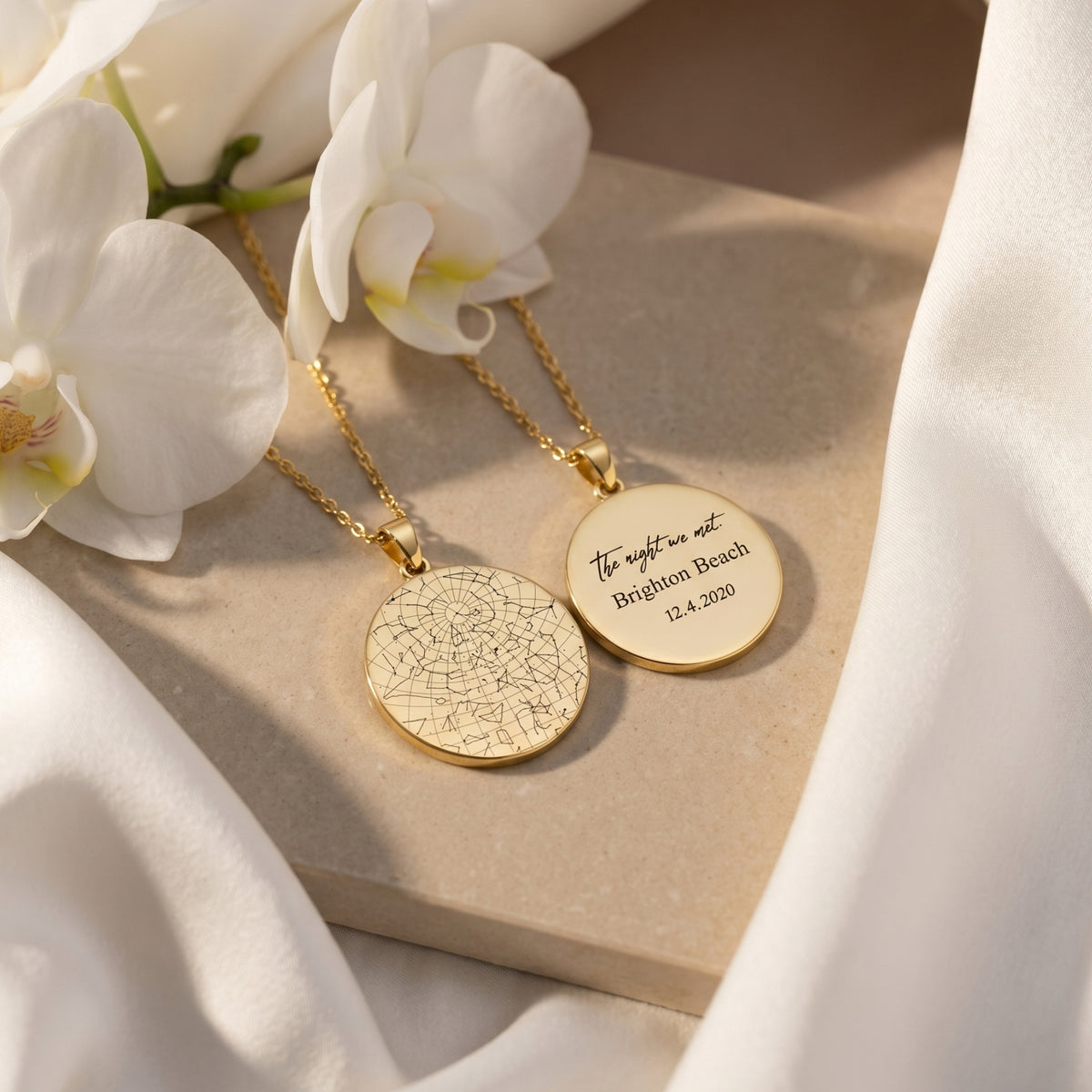 Gold stainless steel necklaces showing star map and personalized text engraving with orchids.