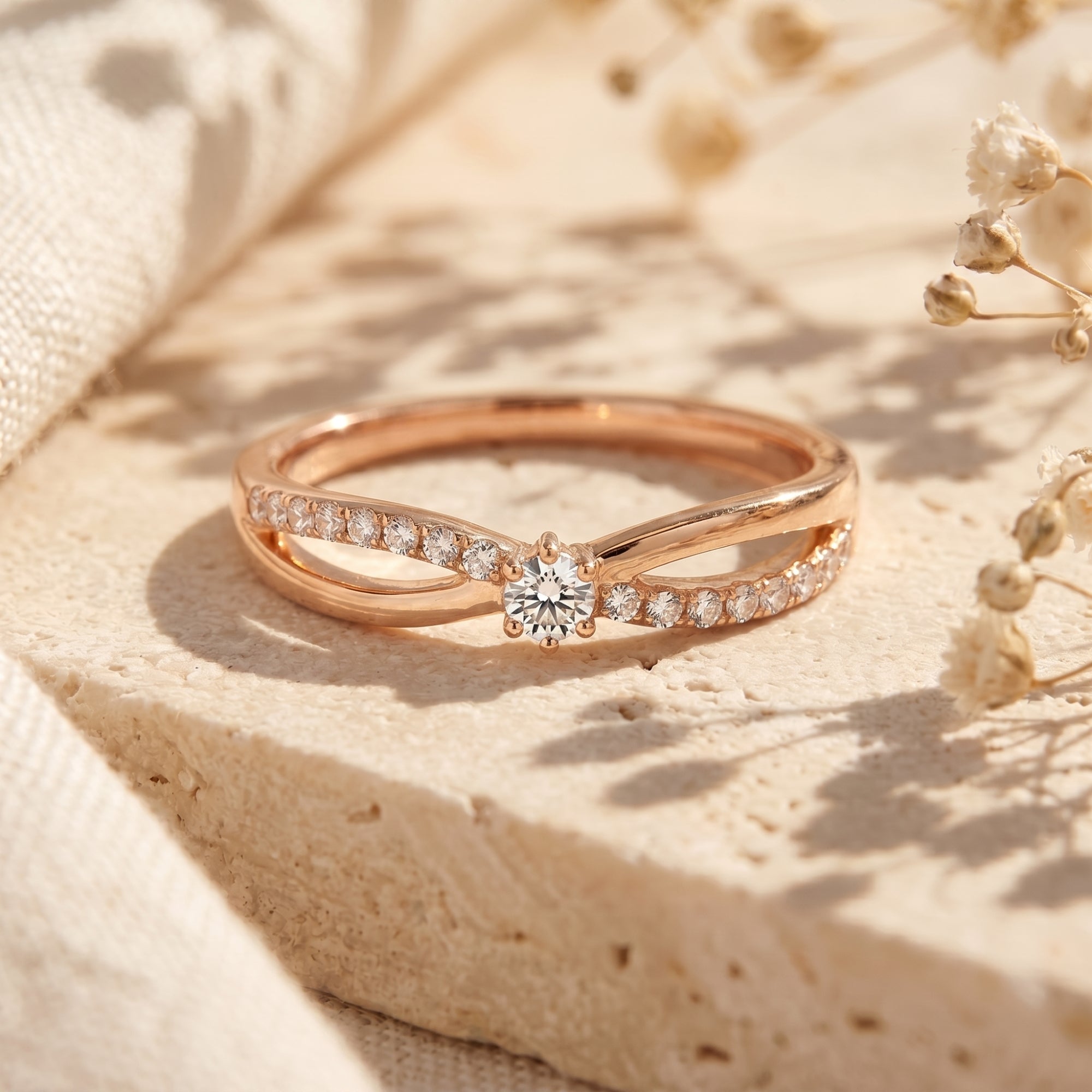 Rose gold bypass promise ring with a round-cut moissanite center stone.