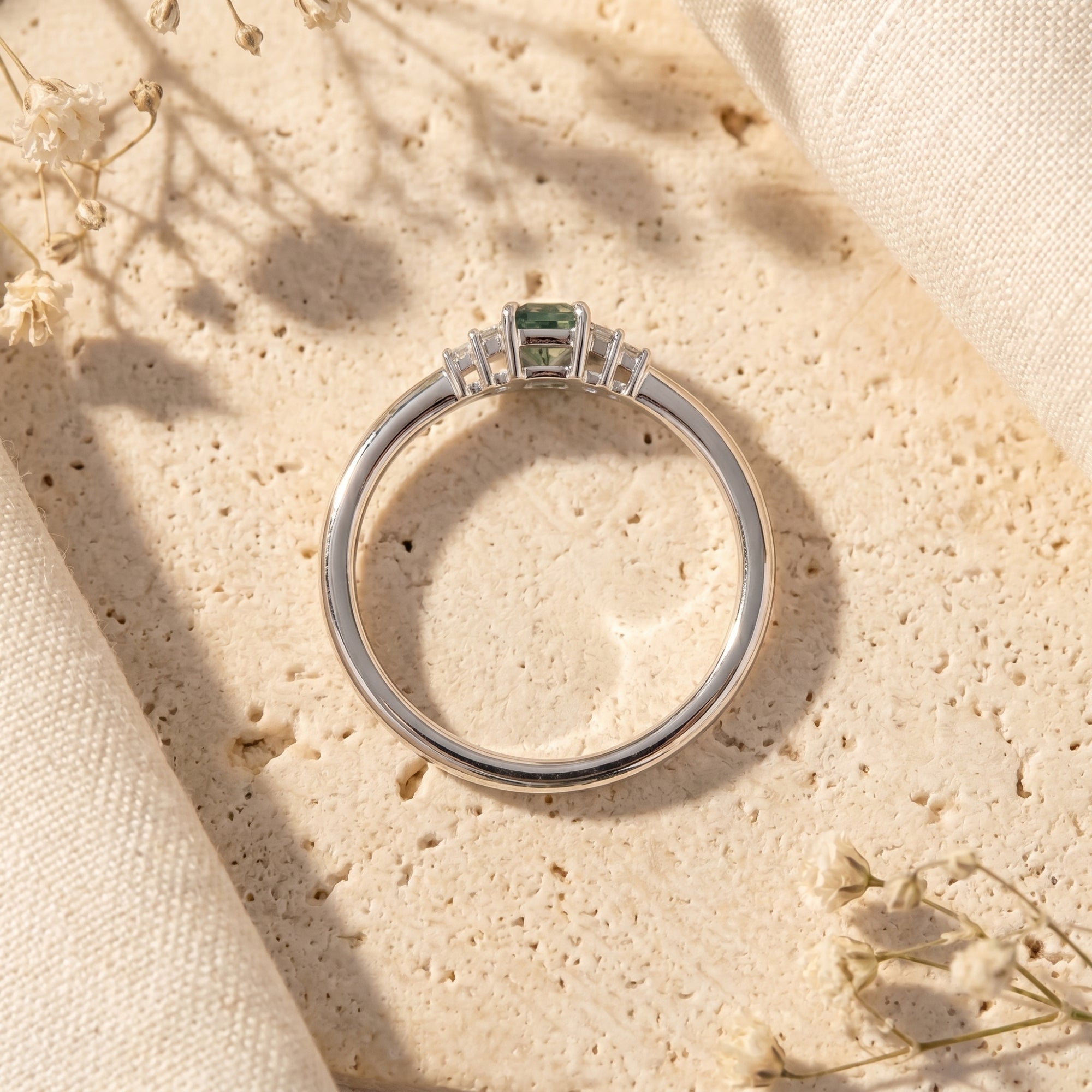 Top view of a sterling silver emerald-cut moss agate ring showing the three-stone baguette setting.