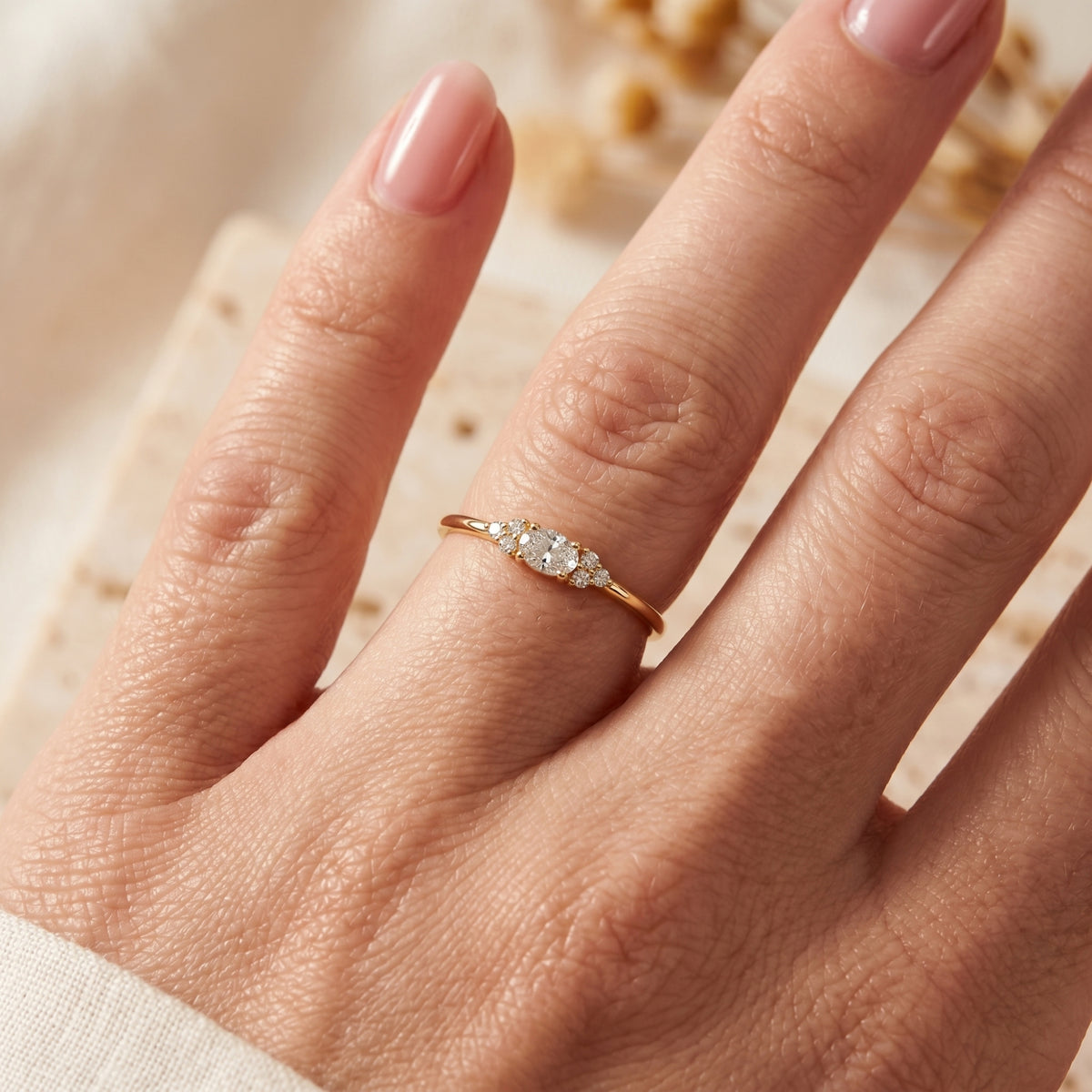 Yellow gold 1-carat oval moissanite ring shown on a hand for fit and scale.
