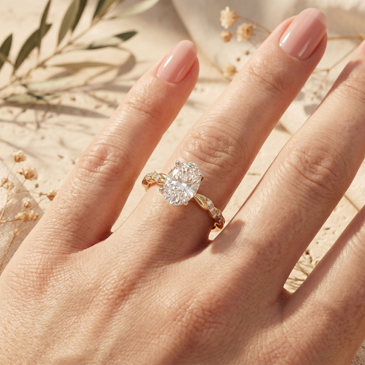 Yellow gold oval moissanite ring on model's hand.